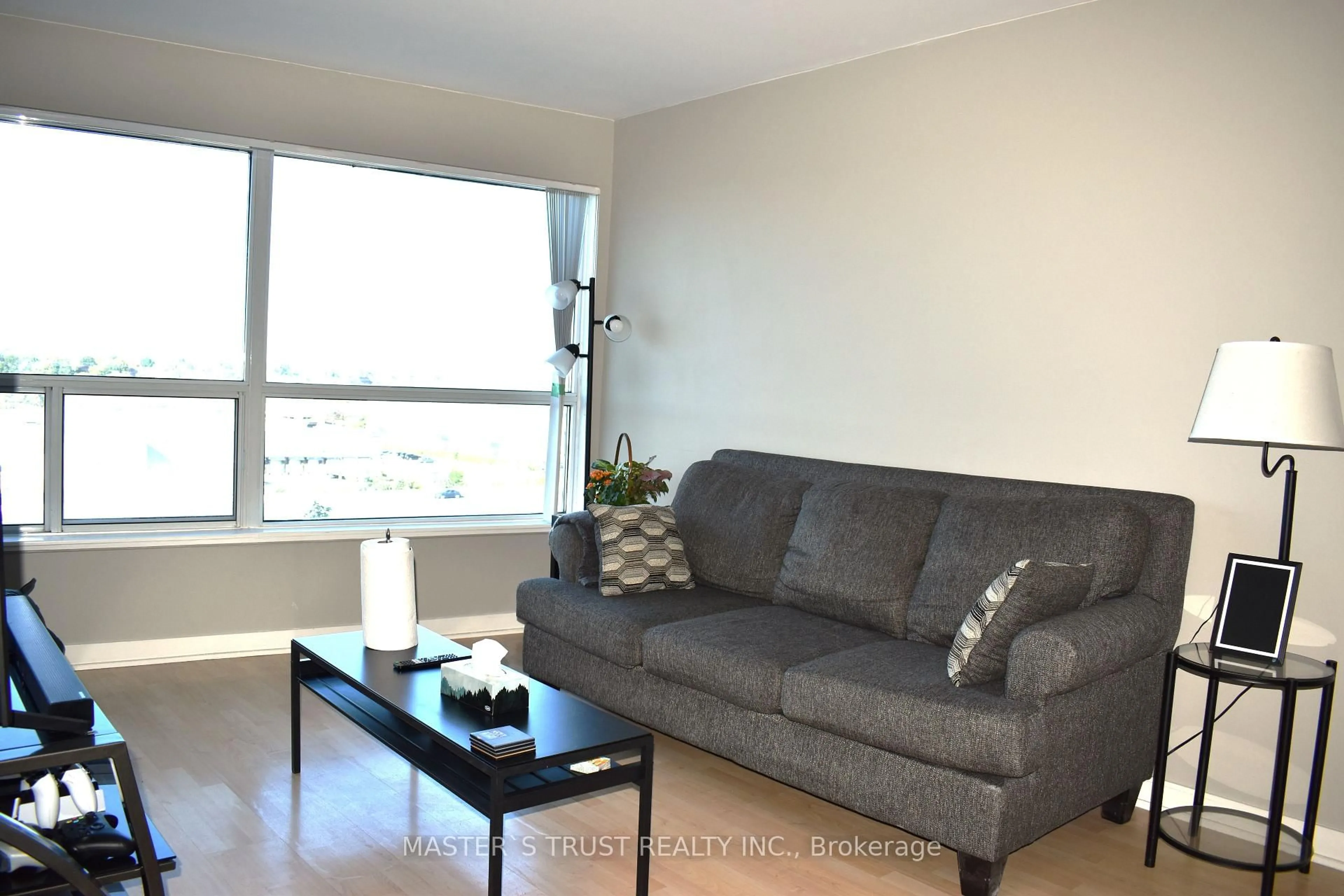 Living room with furniture, wood/laminate floor for 36 Lee Centre Dr #702, Toronto Ontario M1H 3J1