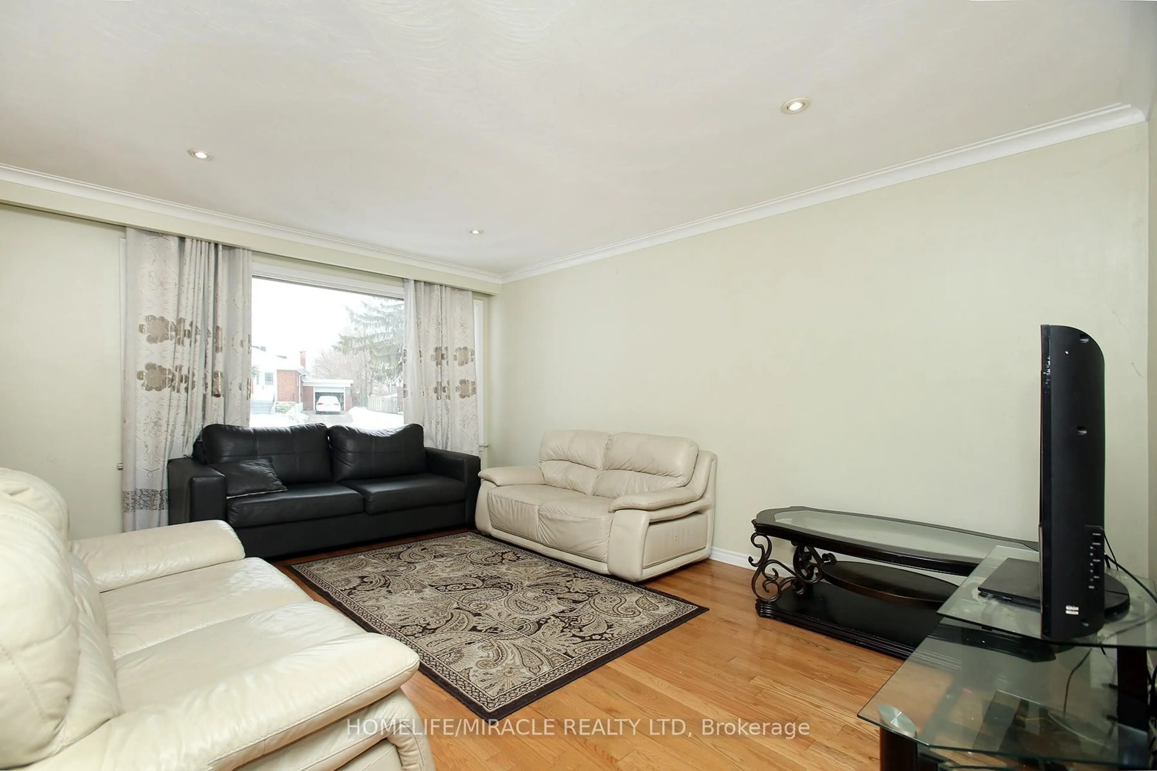 Living room with furniture, wood/laminate floor for 26 Fermoy Rd, Toronto Ontario M1M 3J4