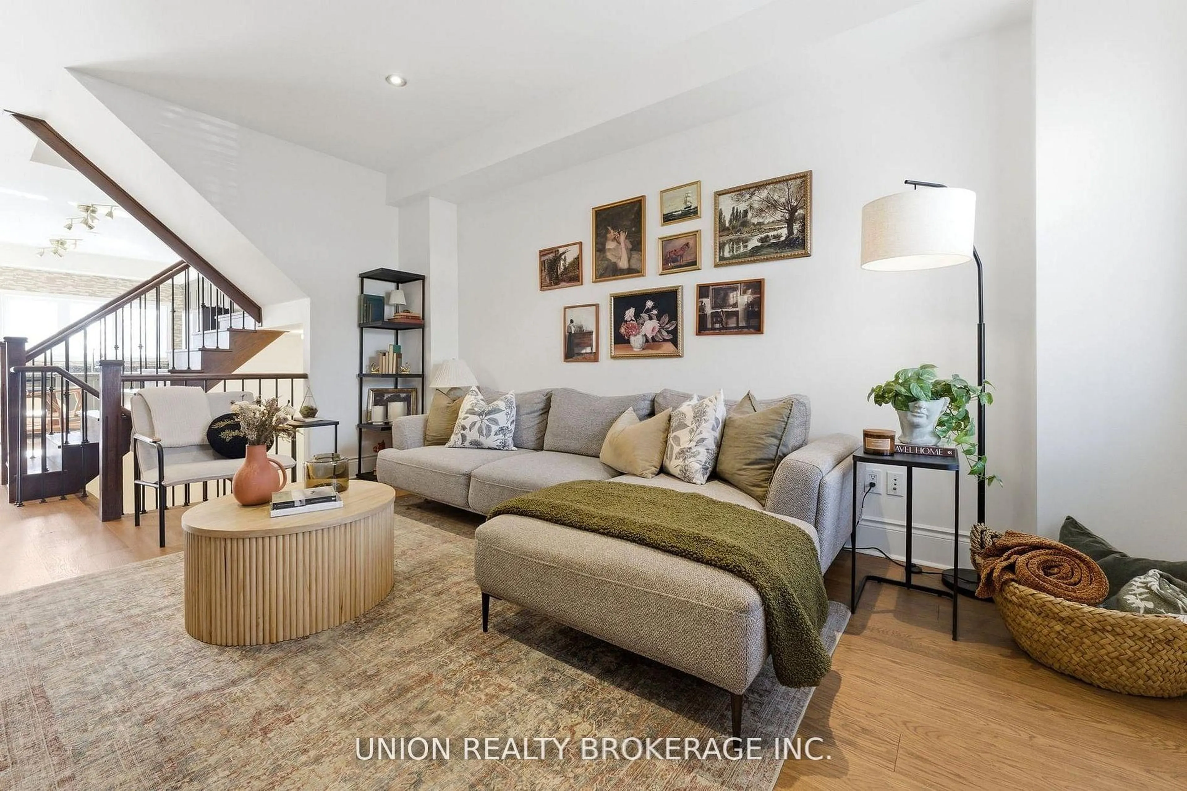 Living room with furniture, wood/laminate floor for 293 Kingston Rd, Toronto Ontario M4L 1T6