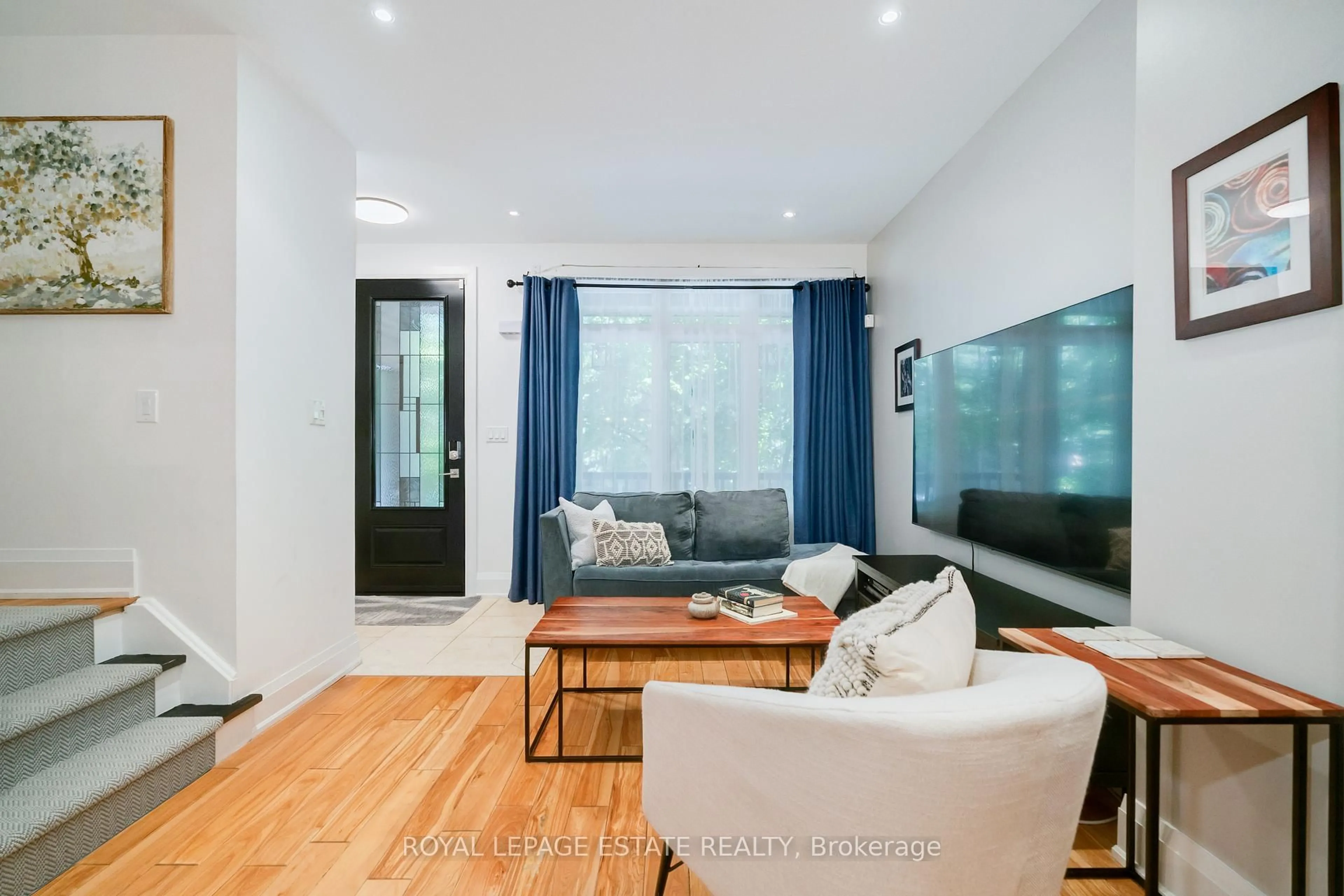 Living room with furniture, wood/laminate floor for 18 Bastedo Ave, Toronto Ontario M4C 3M7