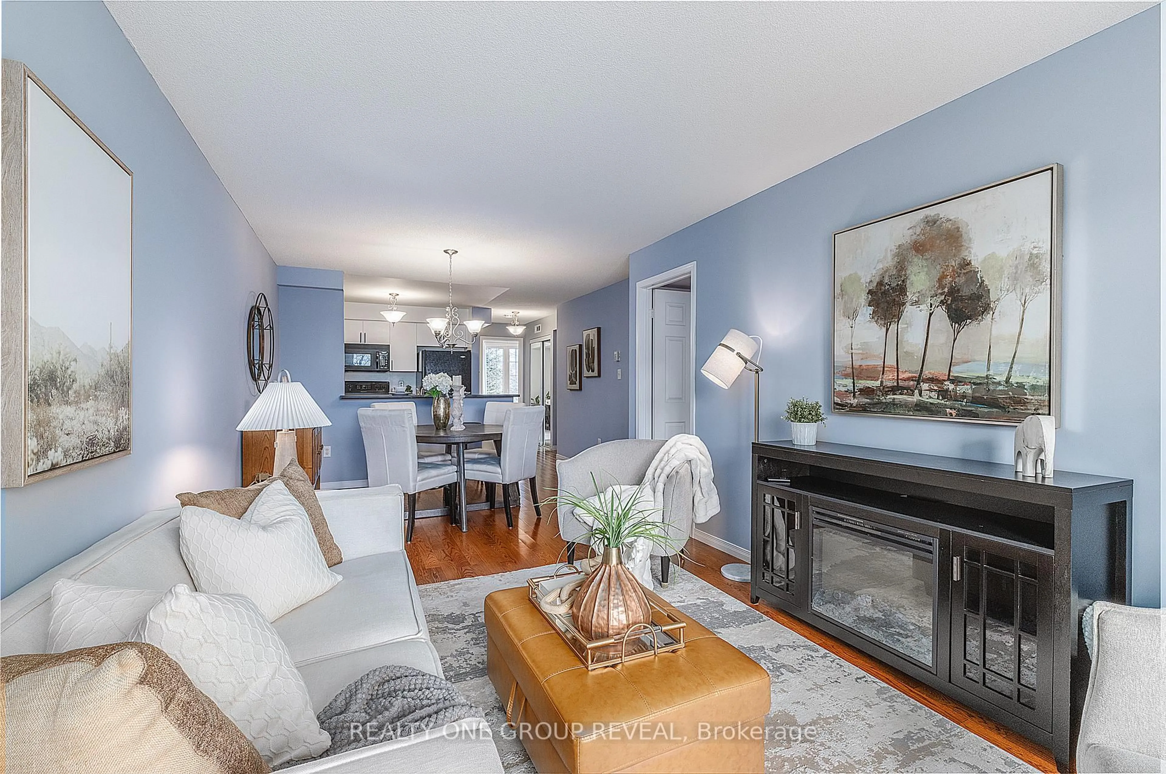 Living room with furniture, wood/laminate floor for 31 Petra Way #2, Whitby Ontario L1R 0A7