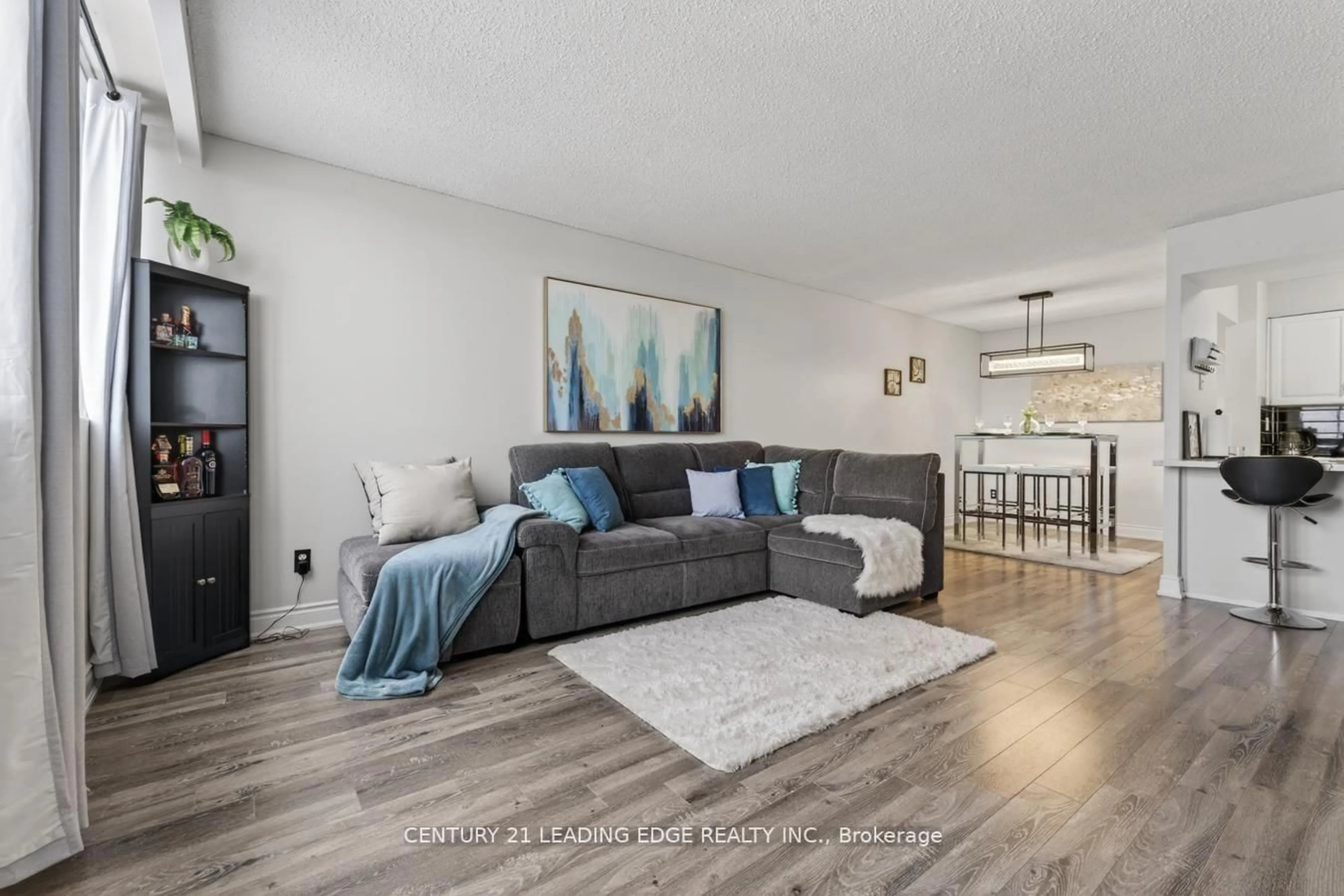 Living room with furniture, wood/laminate floor for 40 Bay Mills Blvd #707, Toronto Ontario M1T 3P5