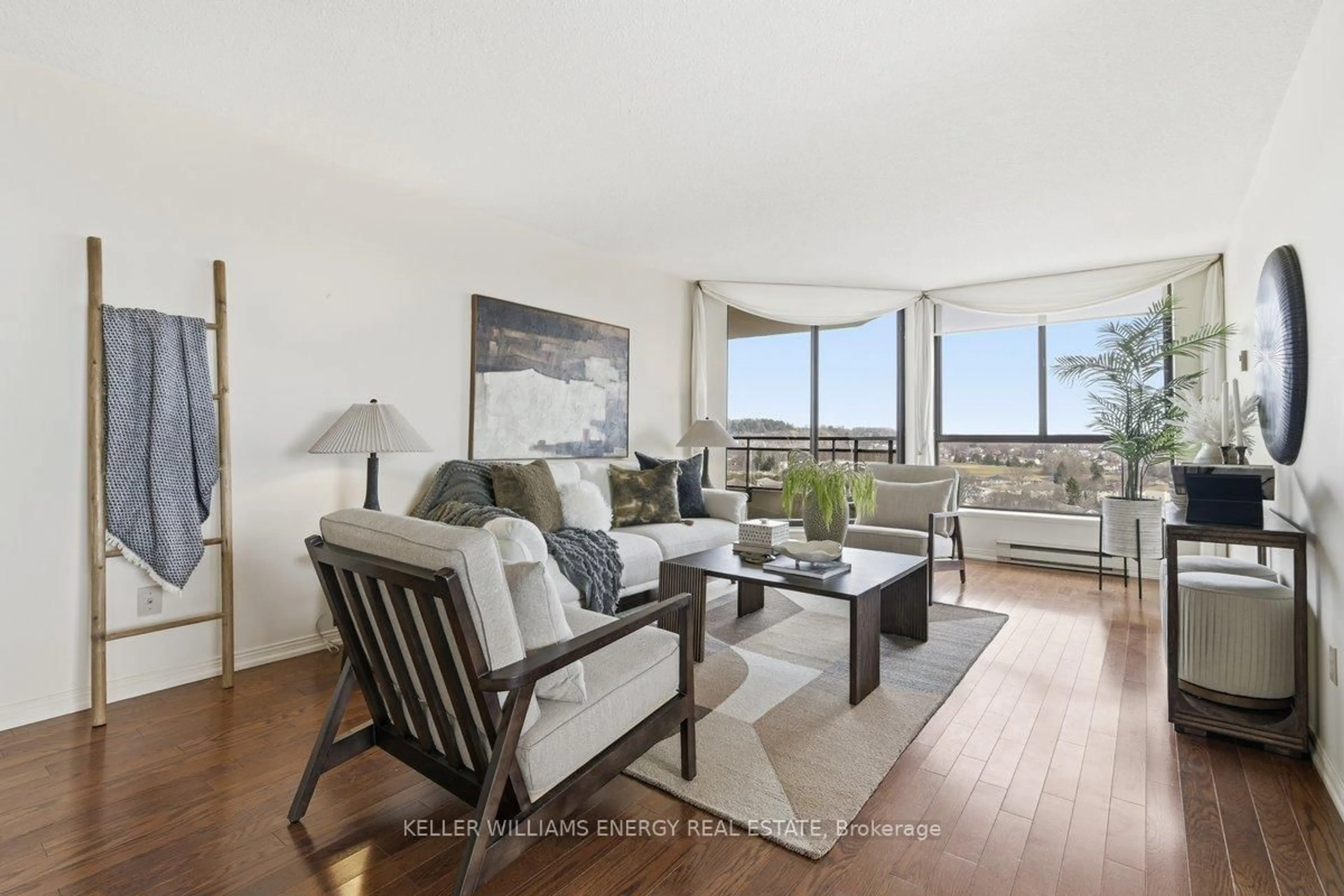 Living room with furniture, wood/laminate floor for 900 Wilson Rd #1304, Oshawa Ontario L1G 7T2