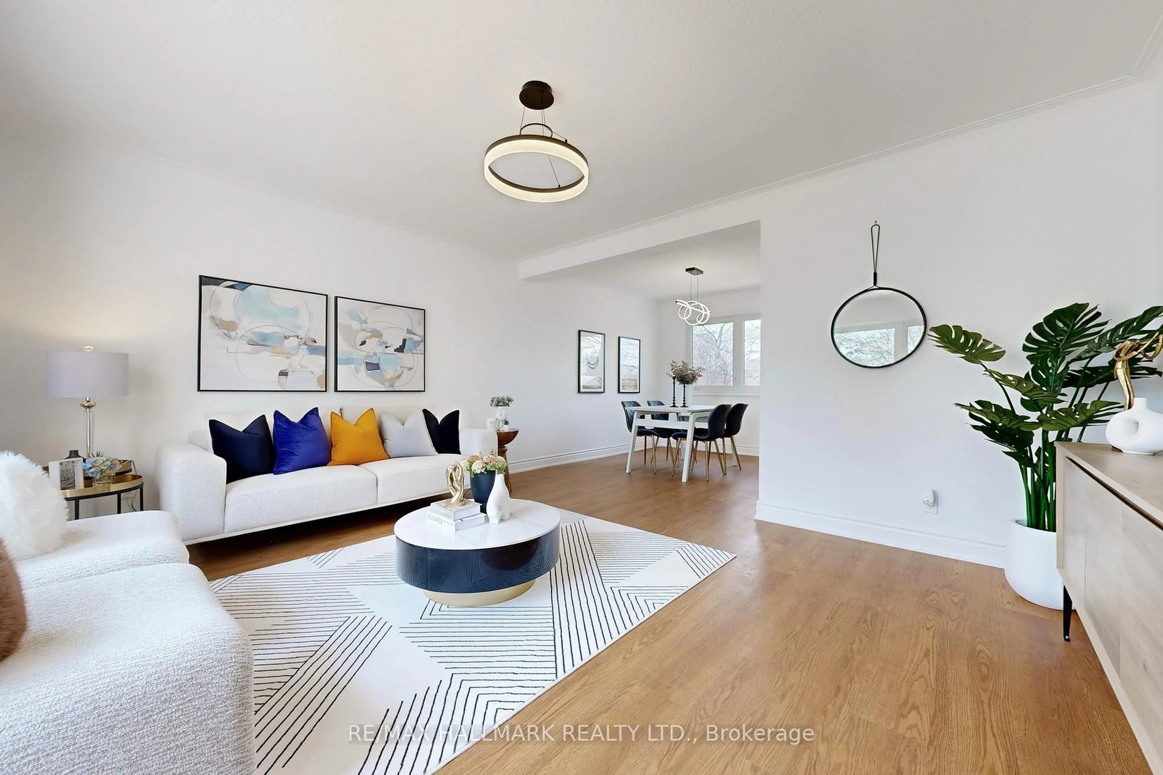 Living room with furniture, wood/laminate floor for 16 Marchington Circ, Toronto Ontario M1R 3M4