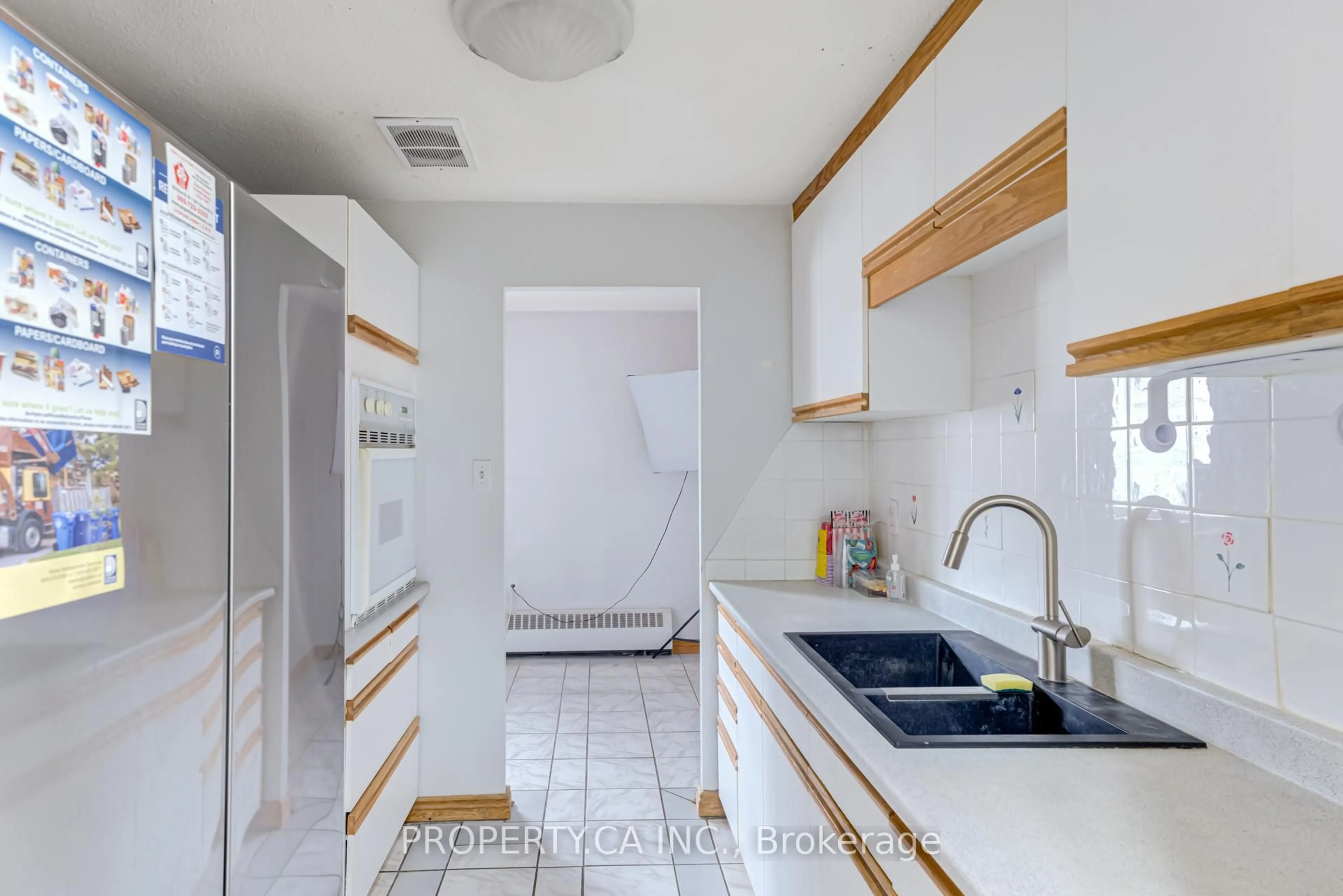 Kitchen with laundary machines, ceramic/tile floor for 936 Glen St #312, Oshawa Ontario L1J 5Z7