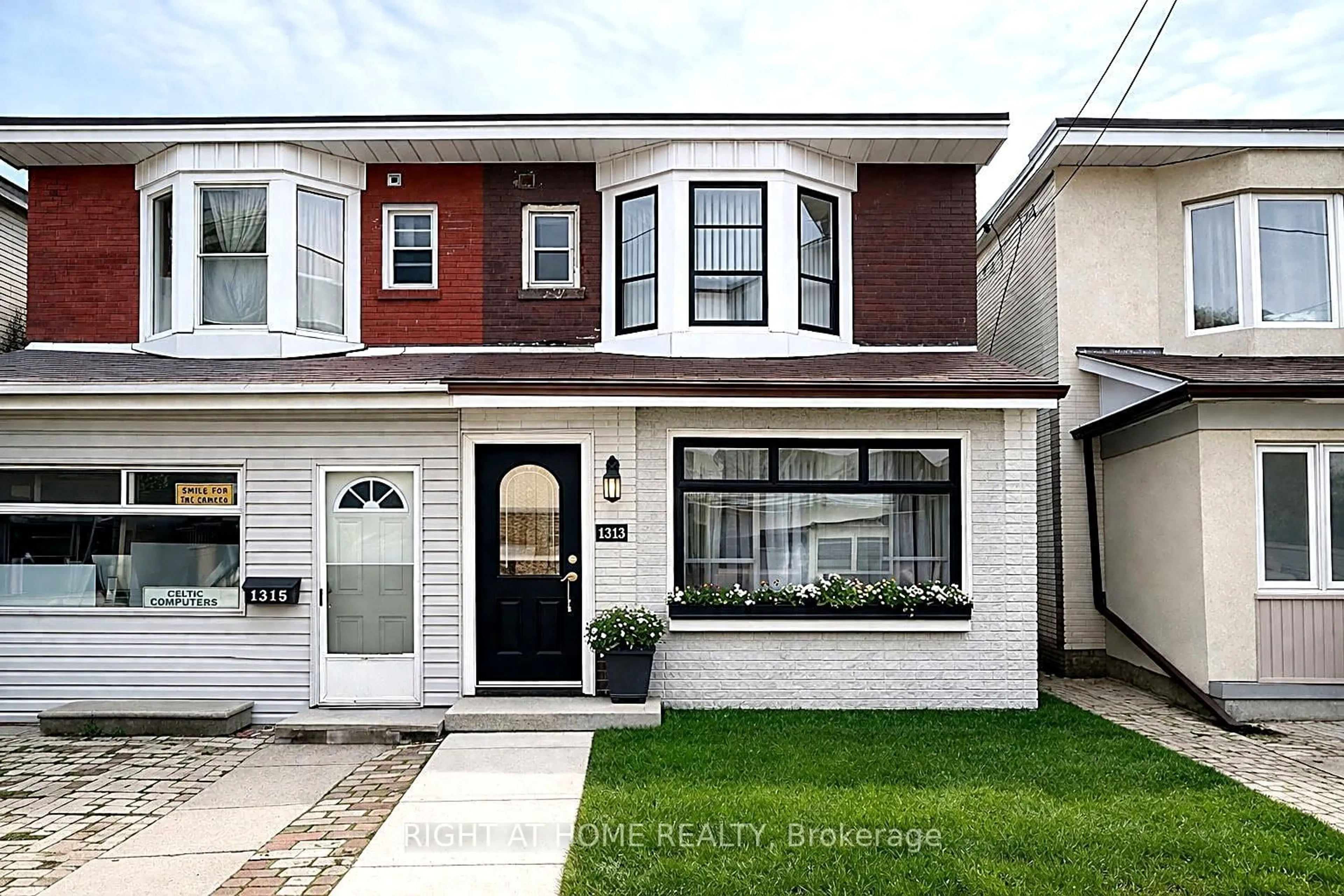 Home with vinyl exterior material, street for 1313 Gerrard St, Toronto Ontario M4L 1Y8