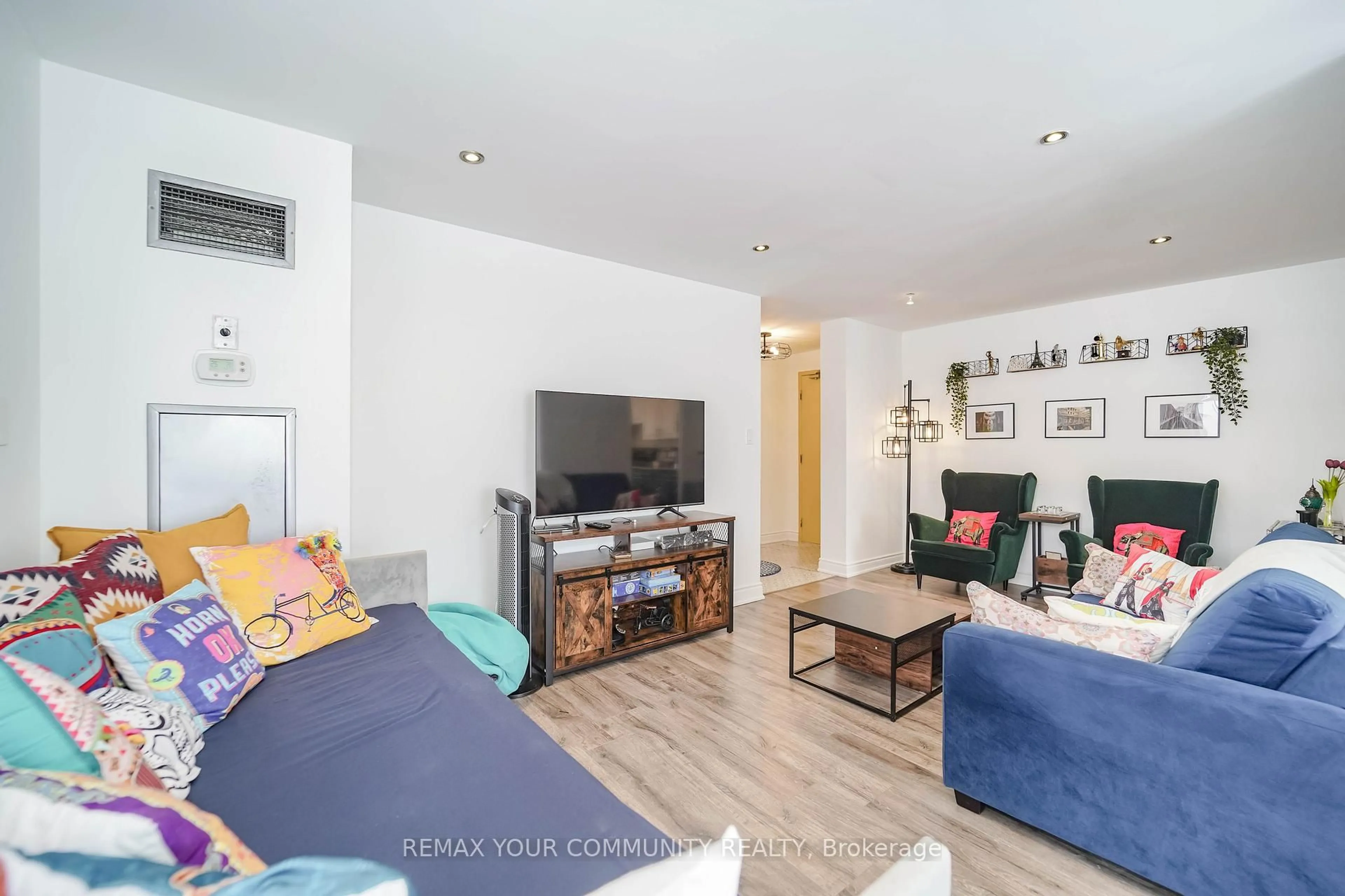 Living room with furniture, wood/laminate floor for 410 McLevin Ave #103, Toronto Ontario M1B 5J5