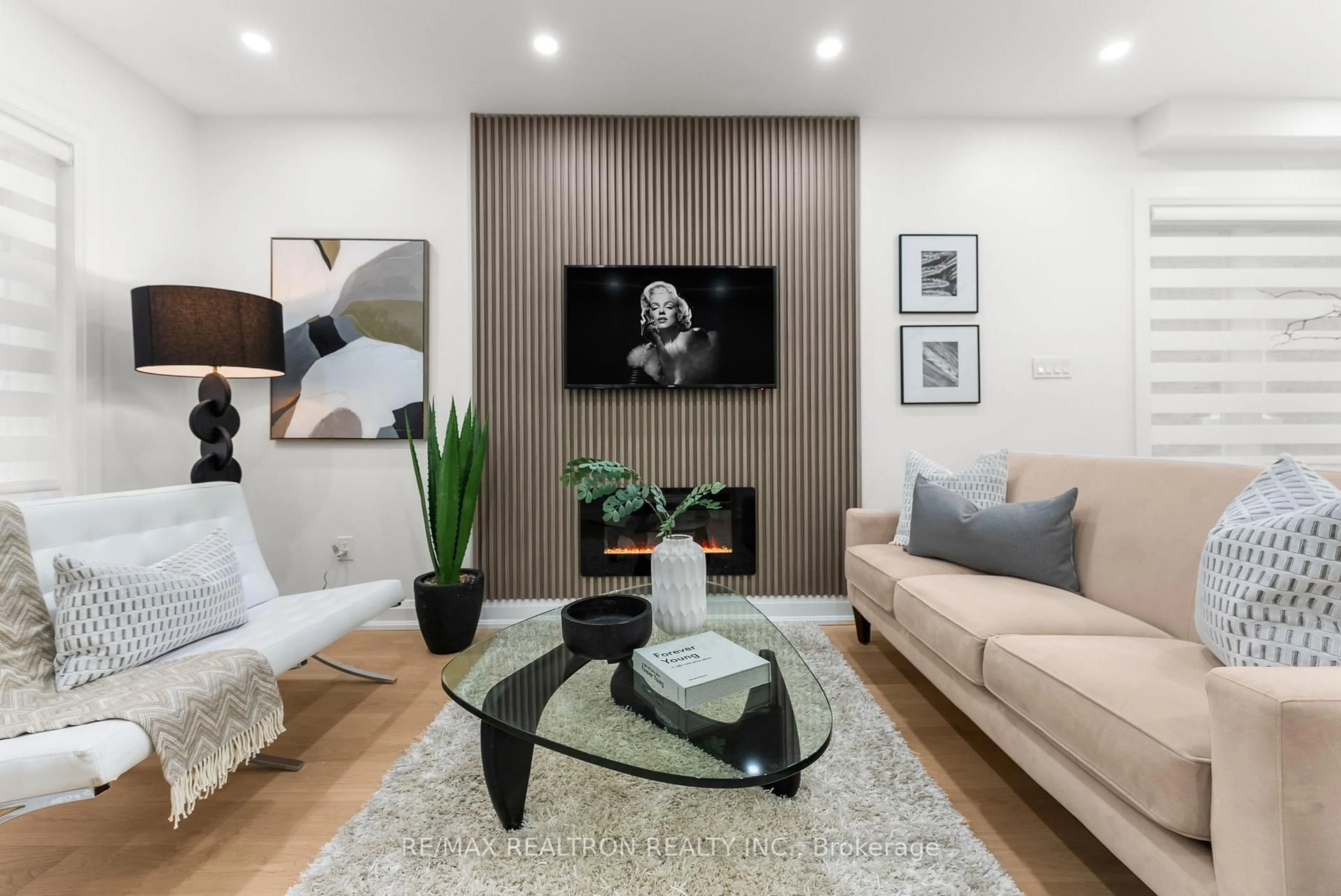 Living room with furniture, wood/laminate floor for 111 Glenmore Rd, Toronto Ontario M4L 3M2