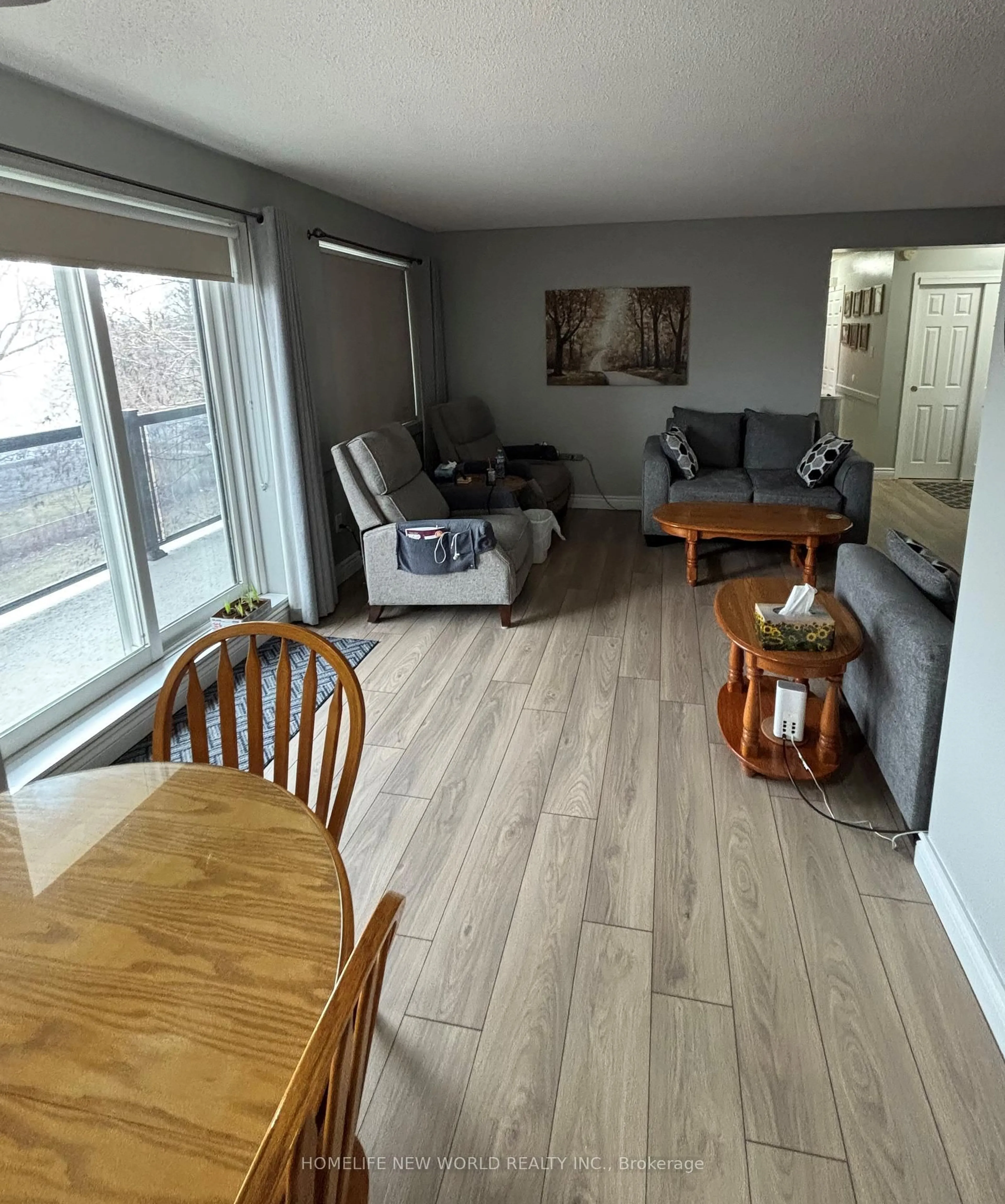 Living room with furniture, wood/laminate floor for 131 Taunton Rd #402, Oshawa Ontario L1G 3T8