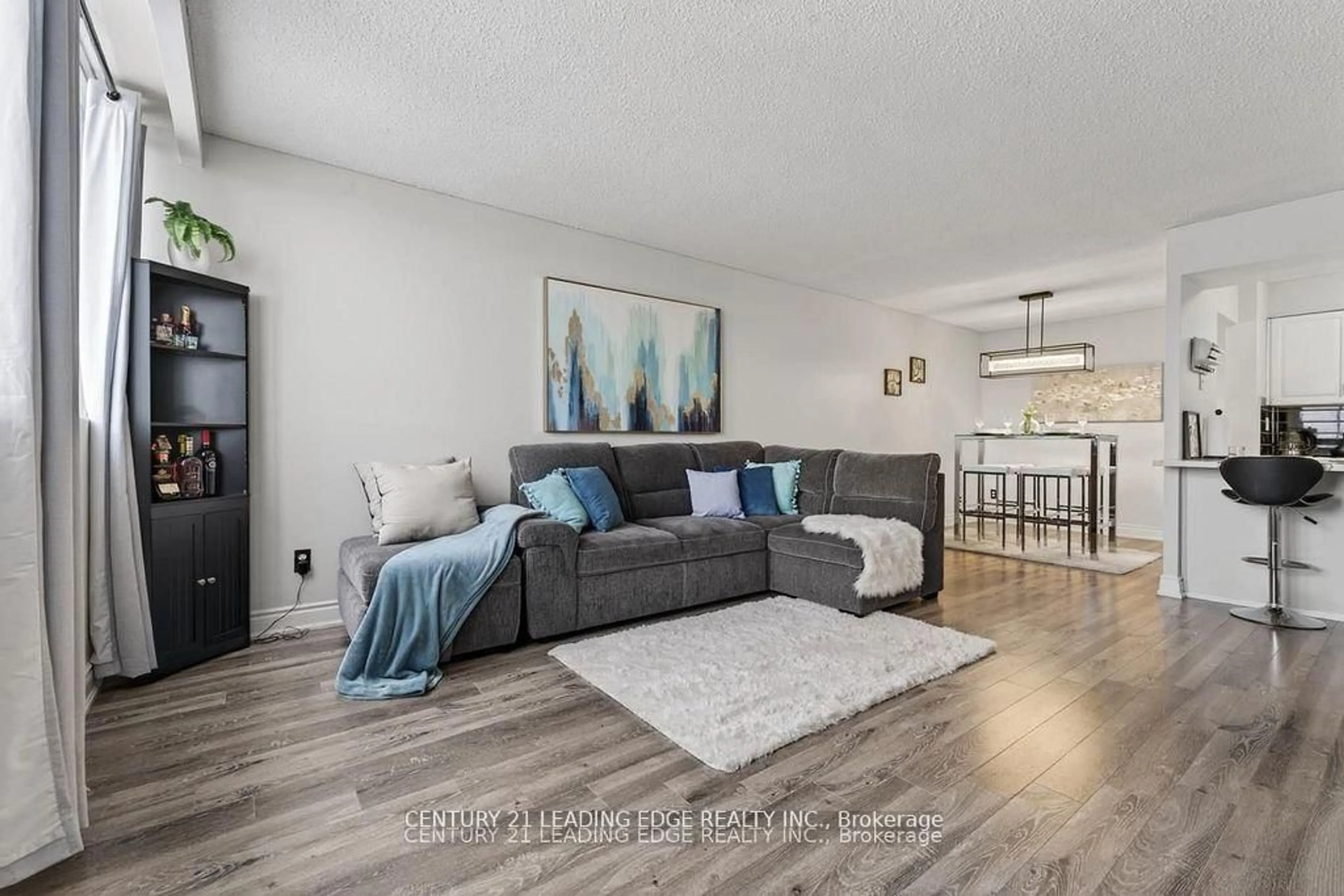Living room with furniture, wood/laminate floor for 40 Bay Mills Blvd #707, Toronto Ontario M1T 3P5