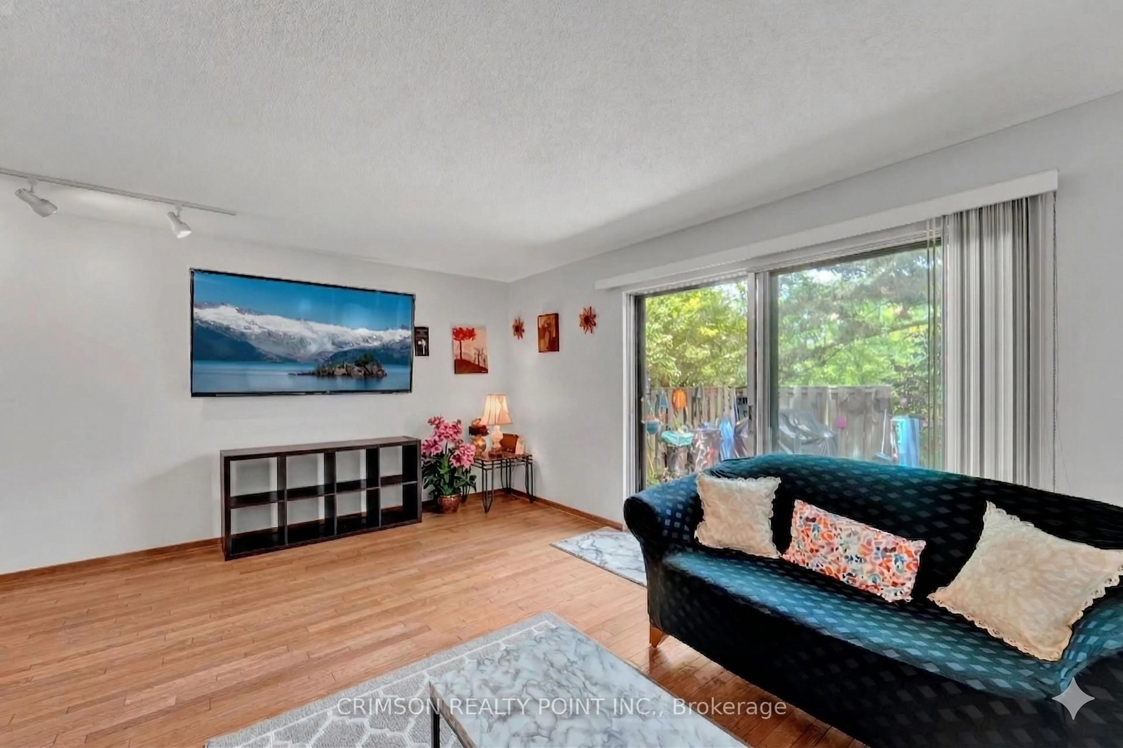 Living room with furniture, wood/laminate floor for 25 Brimwood Blvd #79, Toronto Ontario M1V 1E2