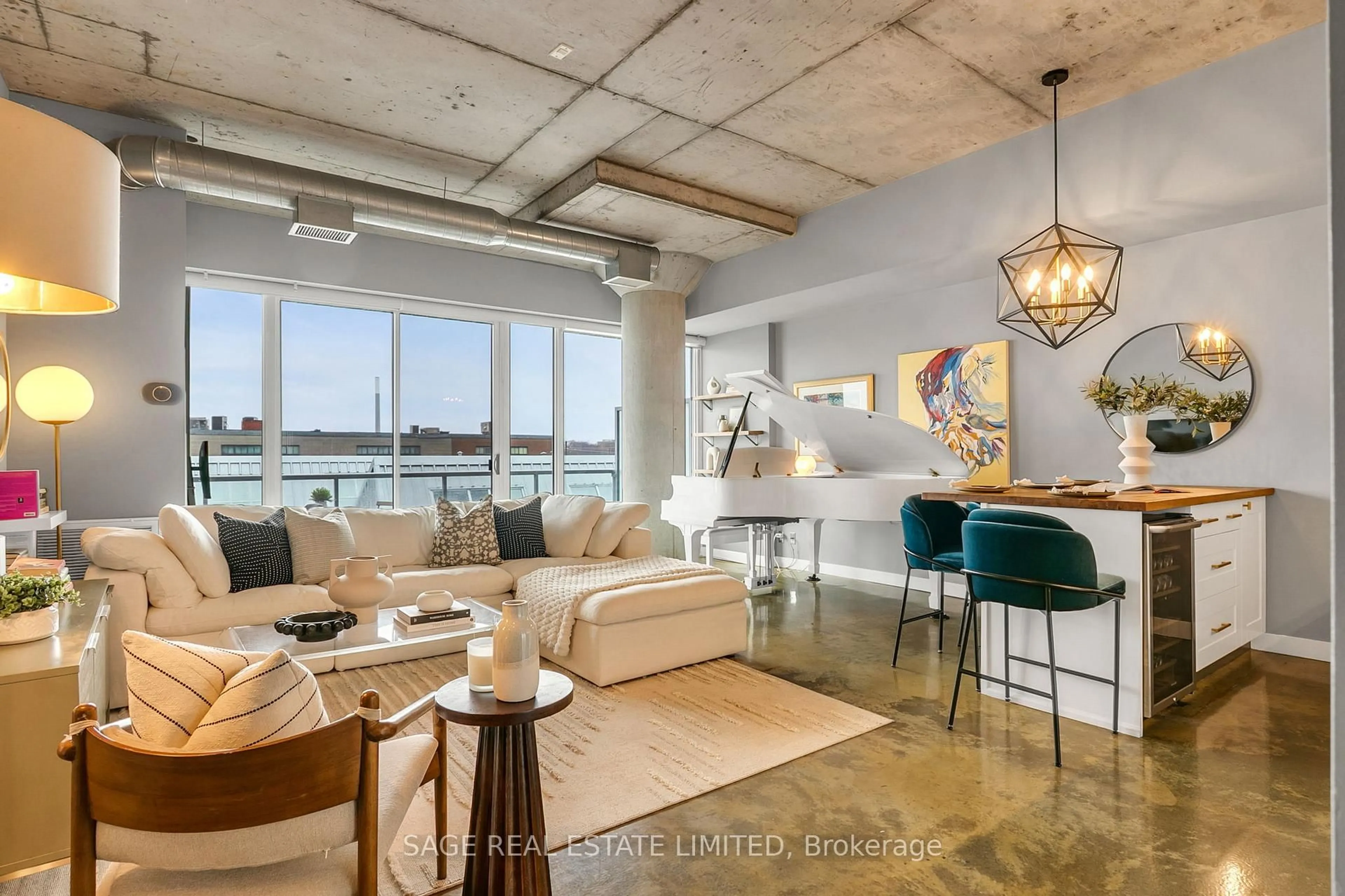 Living room with furniture, cement floor for 201 Carlaw Ave #411, Toronto Ontario M4M 2S3