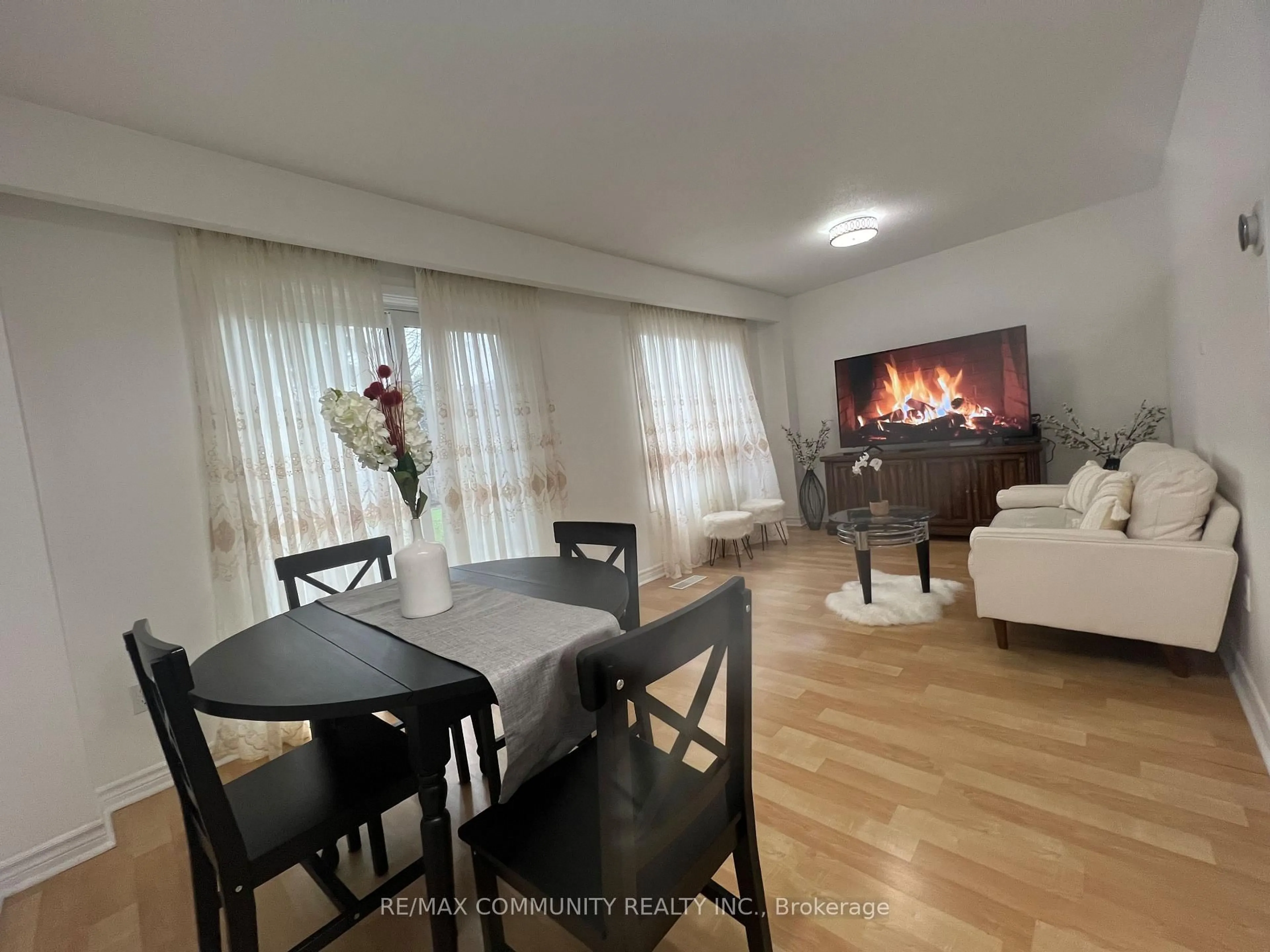 Living room with furniture, wood/laminate floor for 284 Sprucewood Crt, Toronto Ontario M1W 1P8