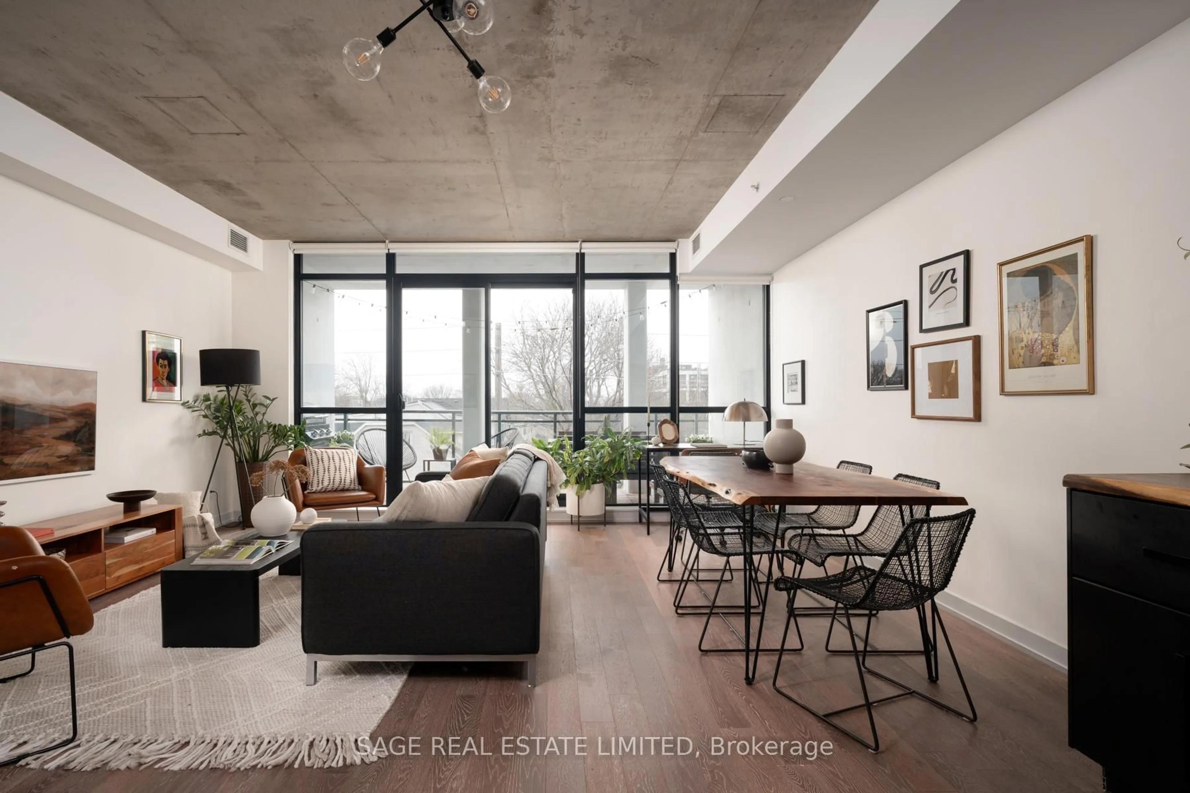 Living room with furniture, cement floor for 1238 Dundas St #403, Toronto Ontario M4M 1S3