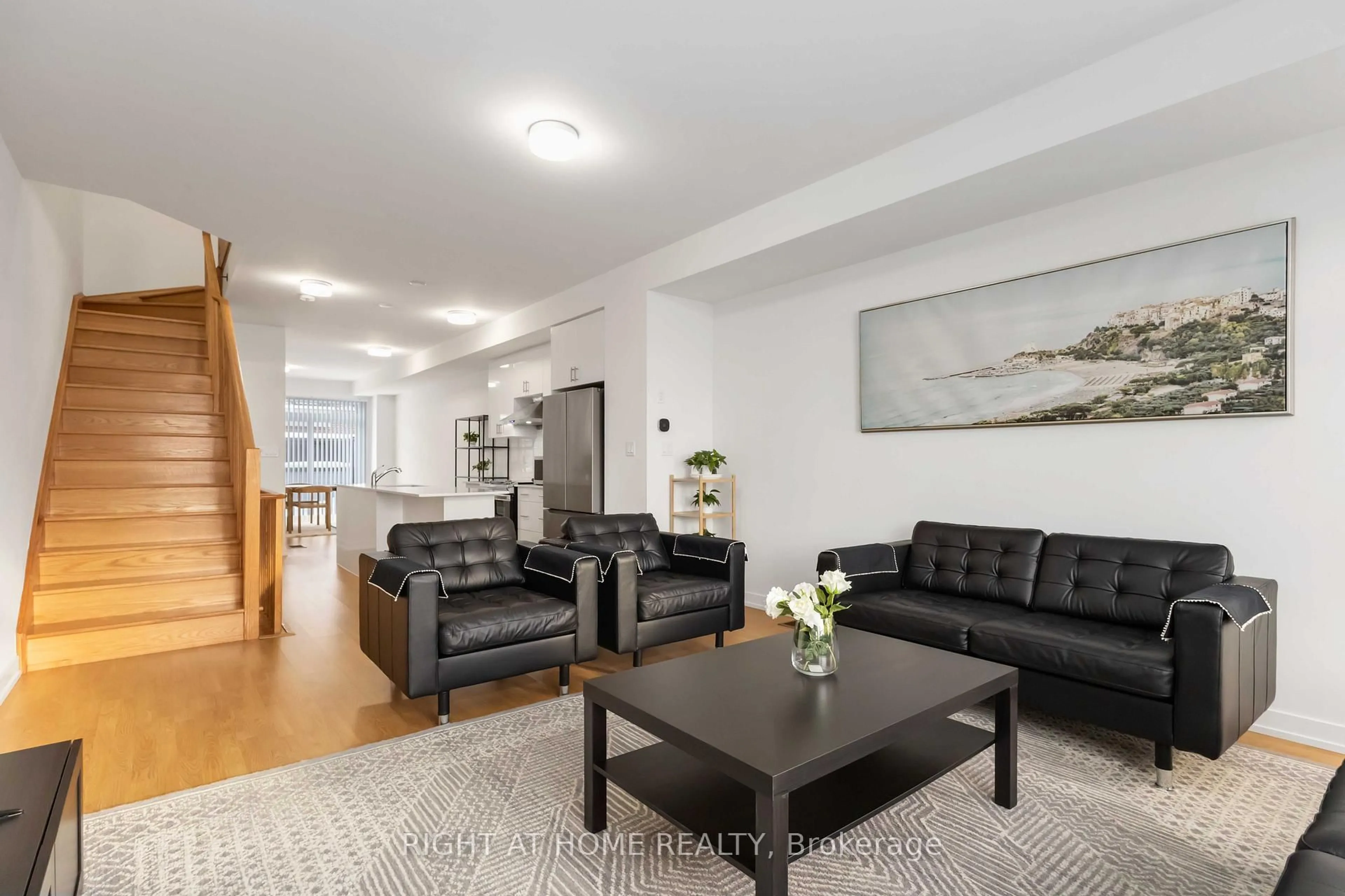 Living room with furniture, wood/laminate floor for 1557 Midland Ave, Toronto Ontario M1P 0G3