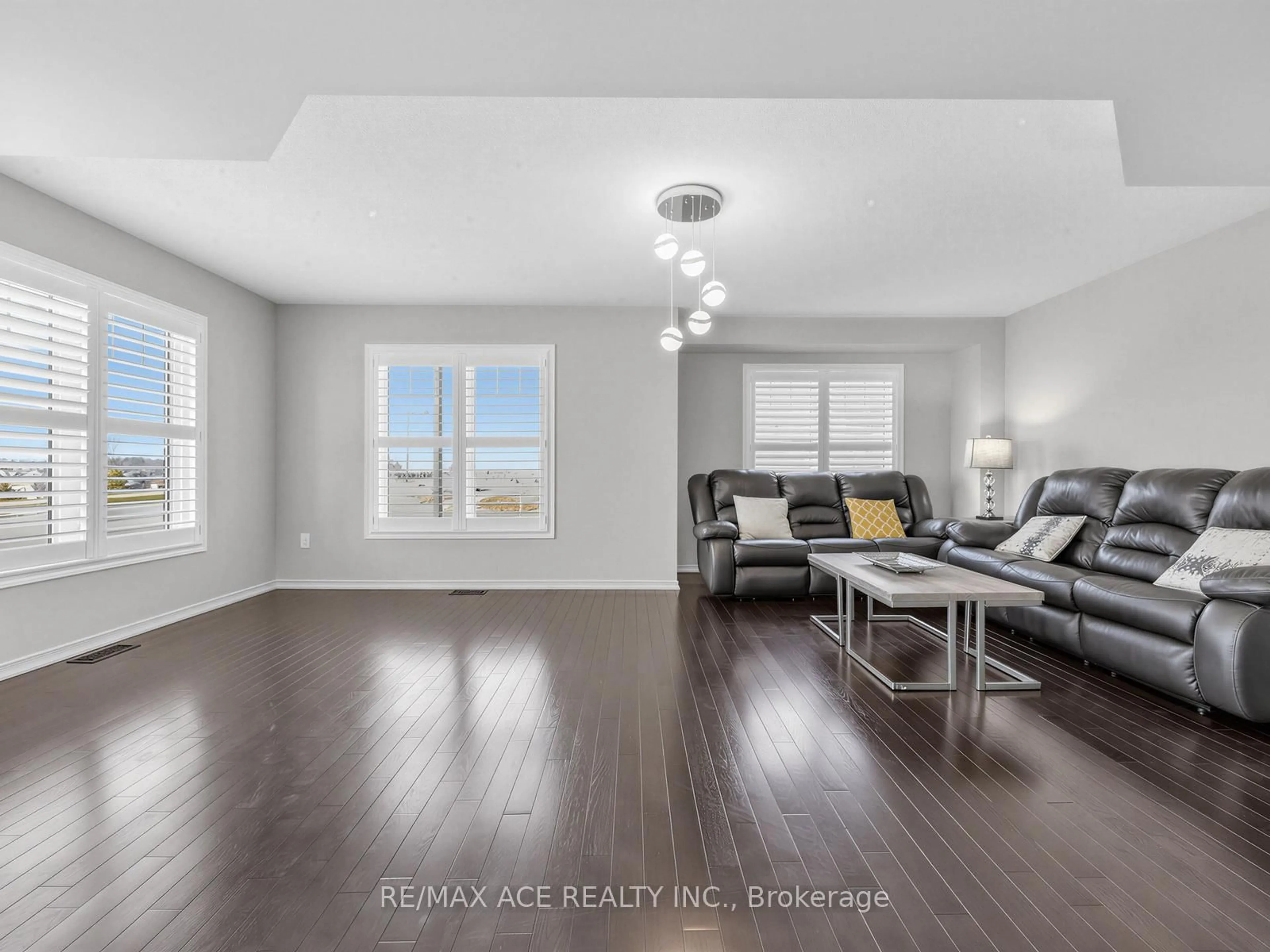 Living room with furniture, wood/laminate floor for 1 Mortlock St, Ajax Ontario L1Z 0T1