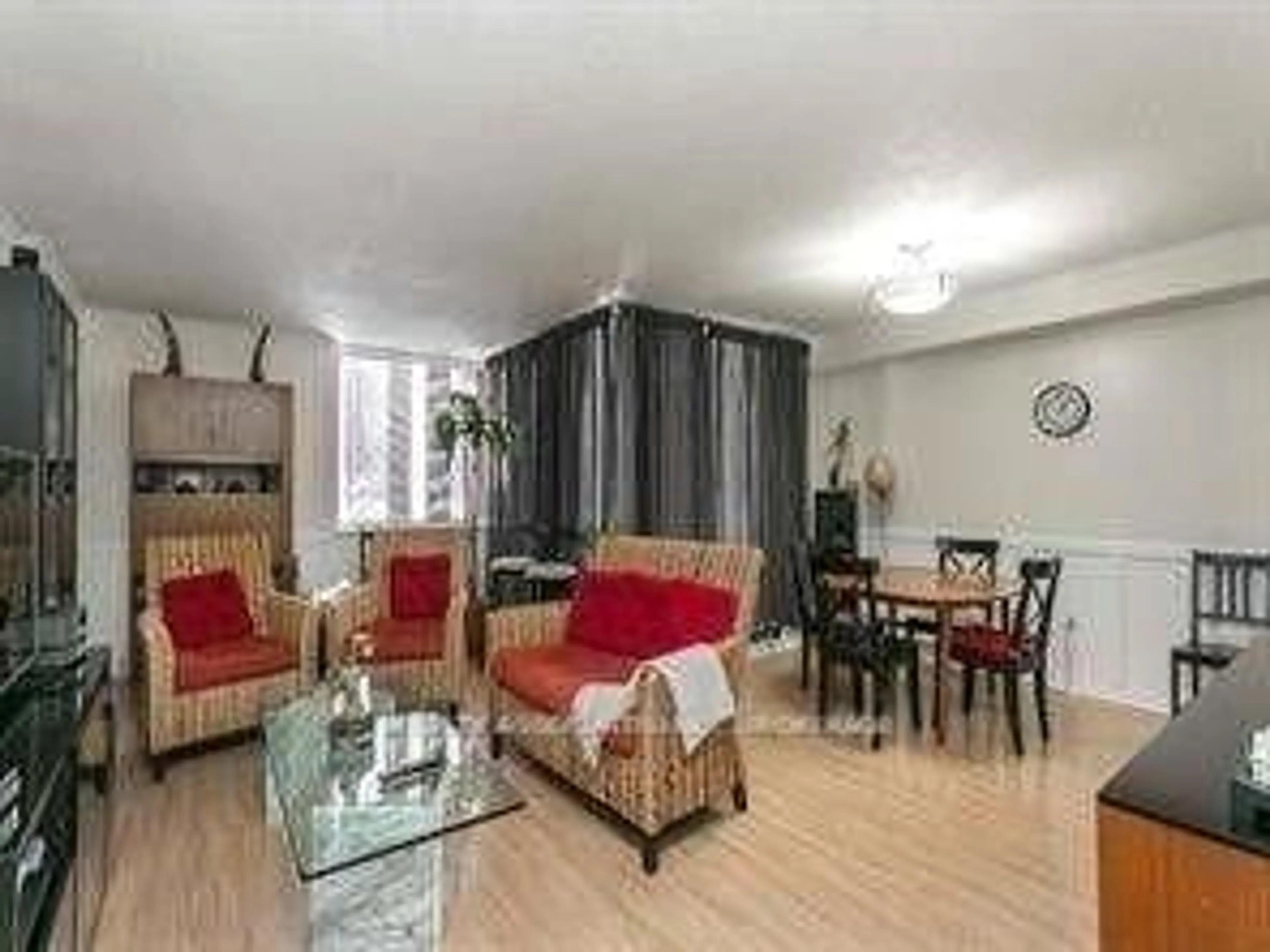 Living room with furniture, wood/laminate floor for 2500 Bridletowne Circ #107, Toronto Ontario M1W 2V6