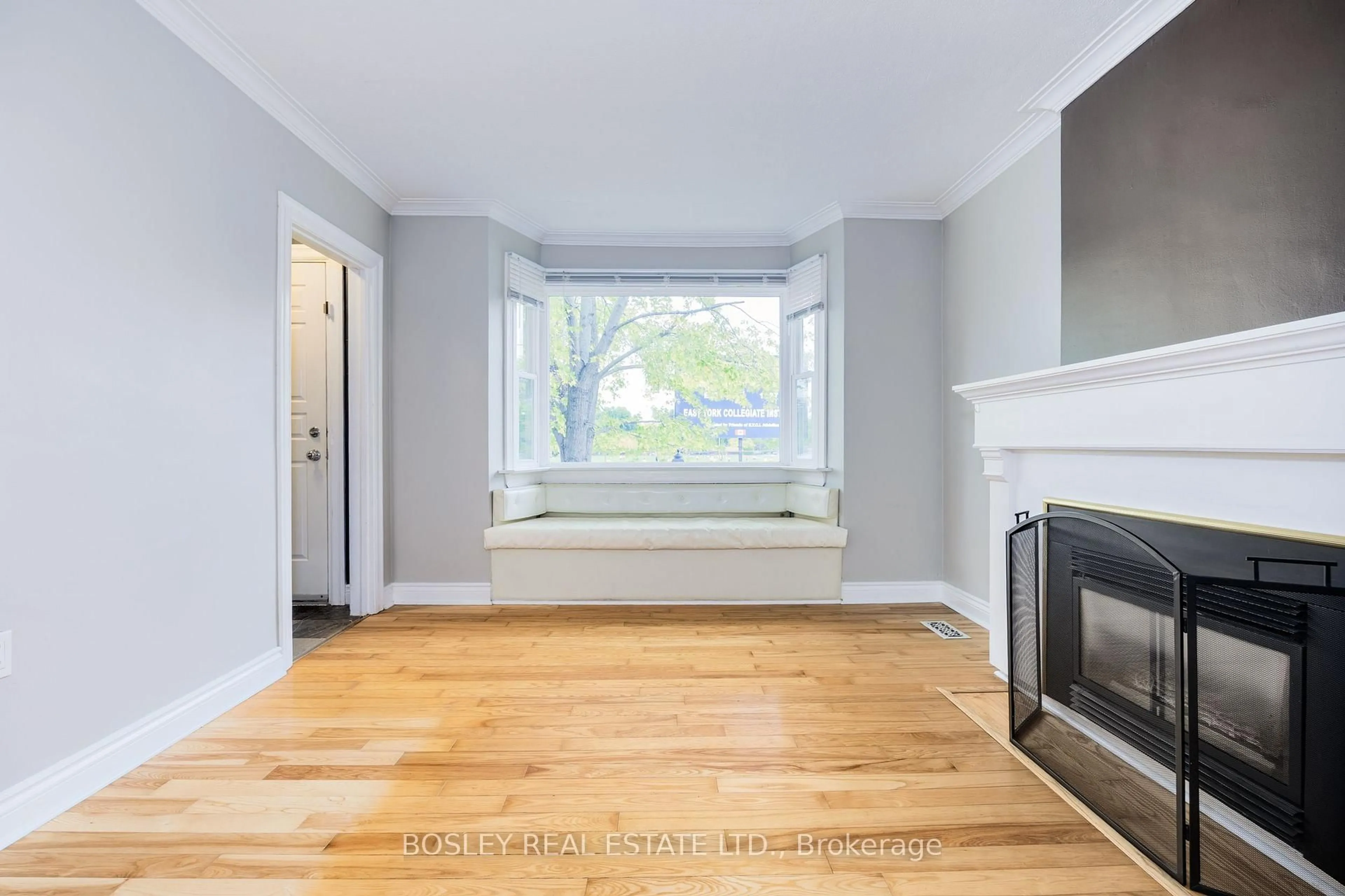Living room with furniture, wood/laminate floor for 651 Cosburn Ave, Toronto Ontario M4C 2V1