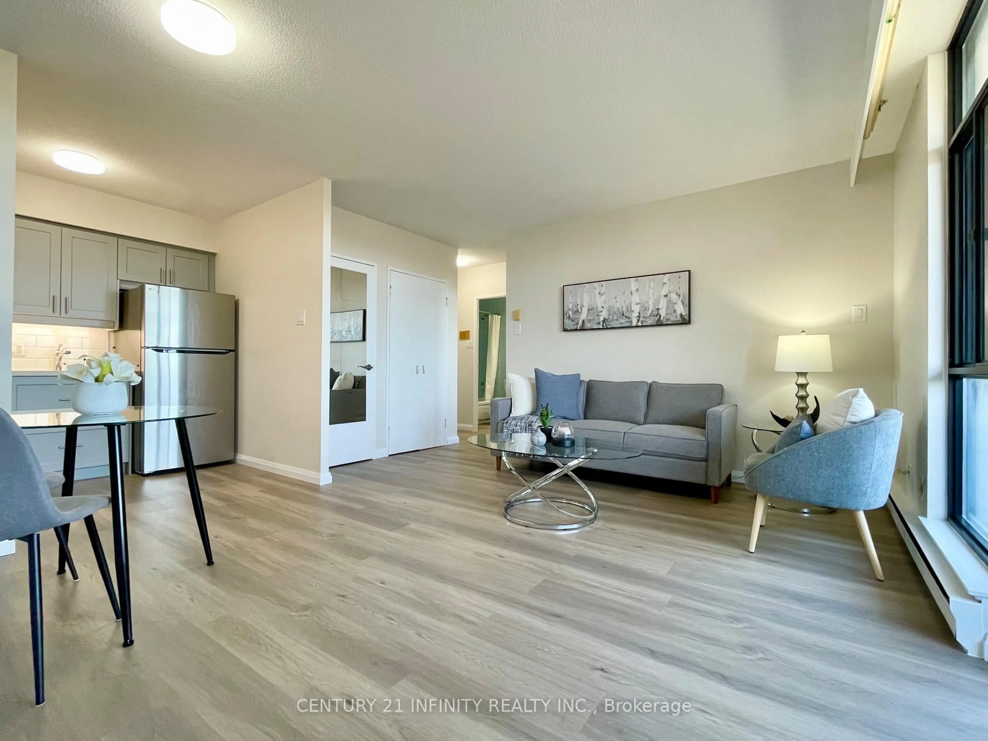 Living room with furniture, wood/laminate floor for 50 Old Kingston Rd #5-606, Toronto Ontario M1E 4Y1