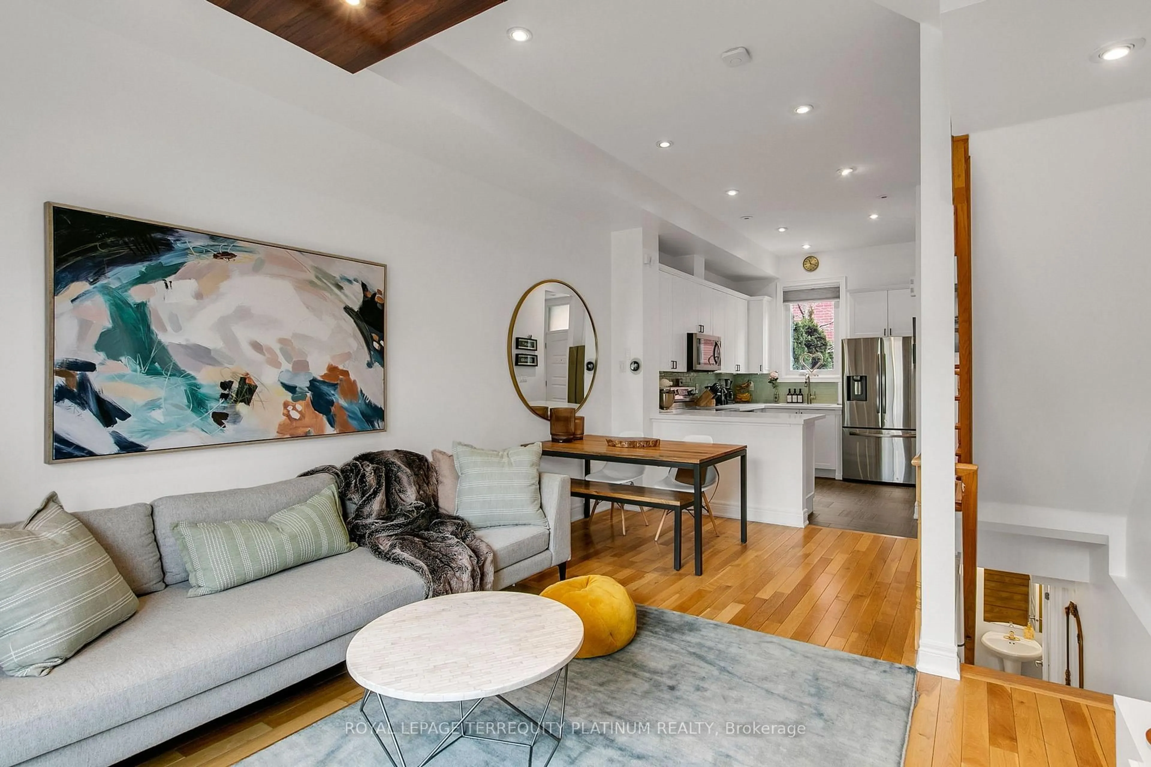 Living room with furniture, wood/laminate floor for 22 Fairhead Mews, Toronto Ontario M4E 3Y4