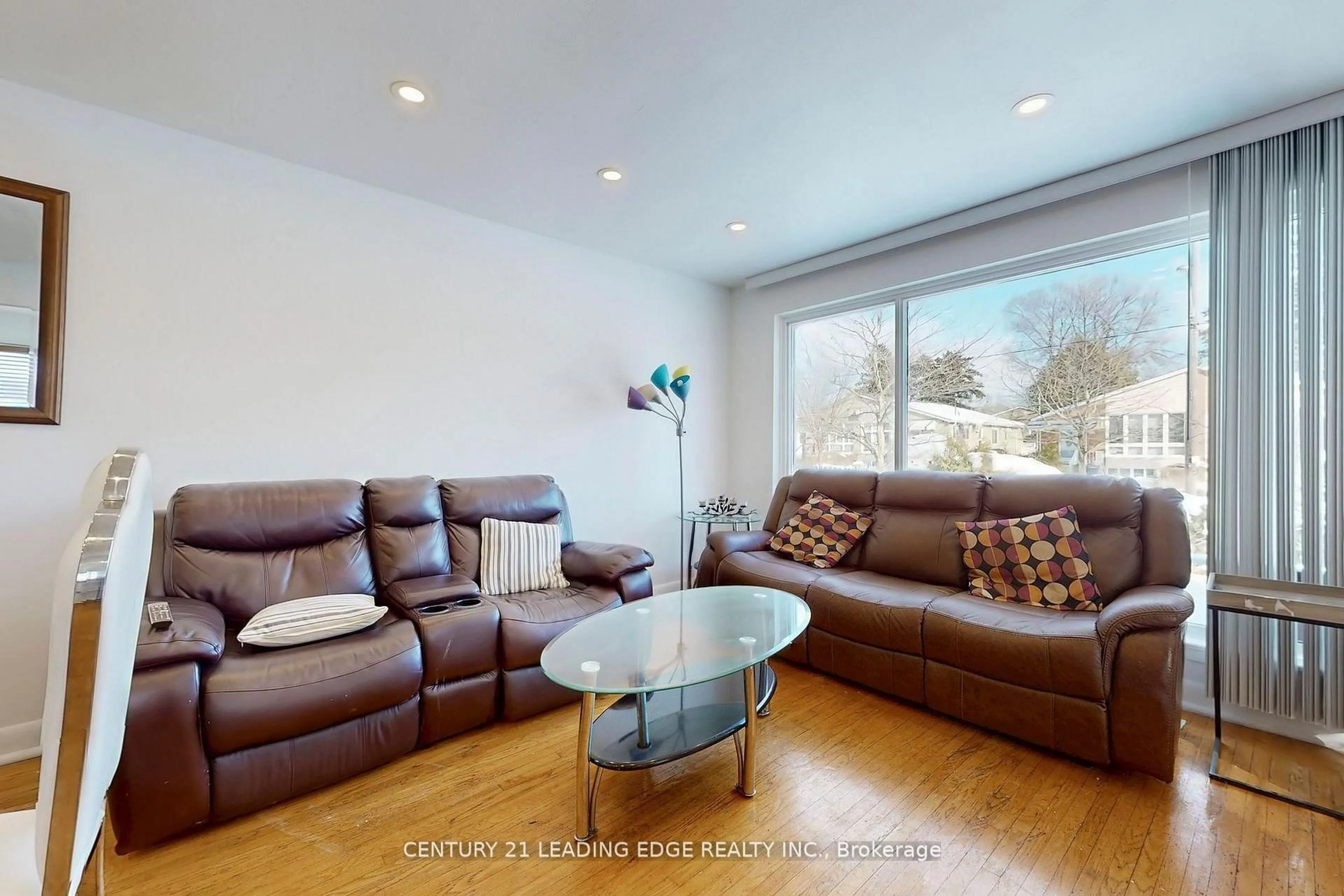 Living room with furniture, wood/laminate floor for 210 Linden Ave, Toronto Ontario M1K 3H8