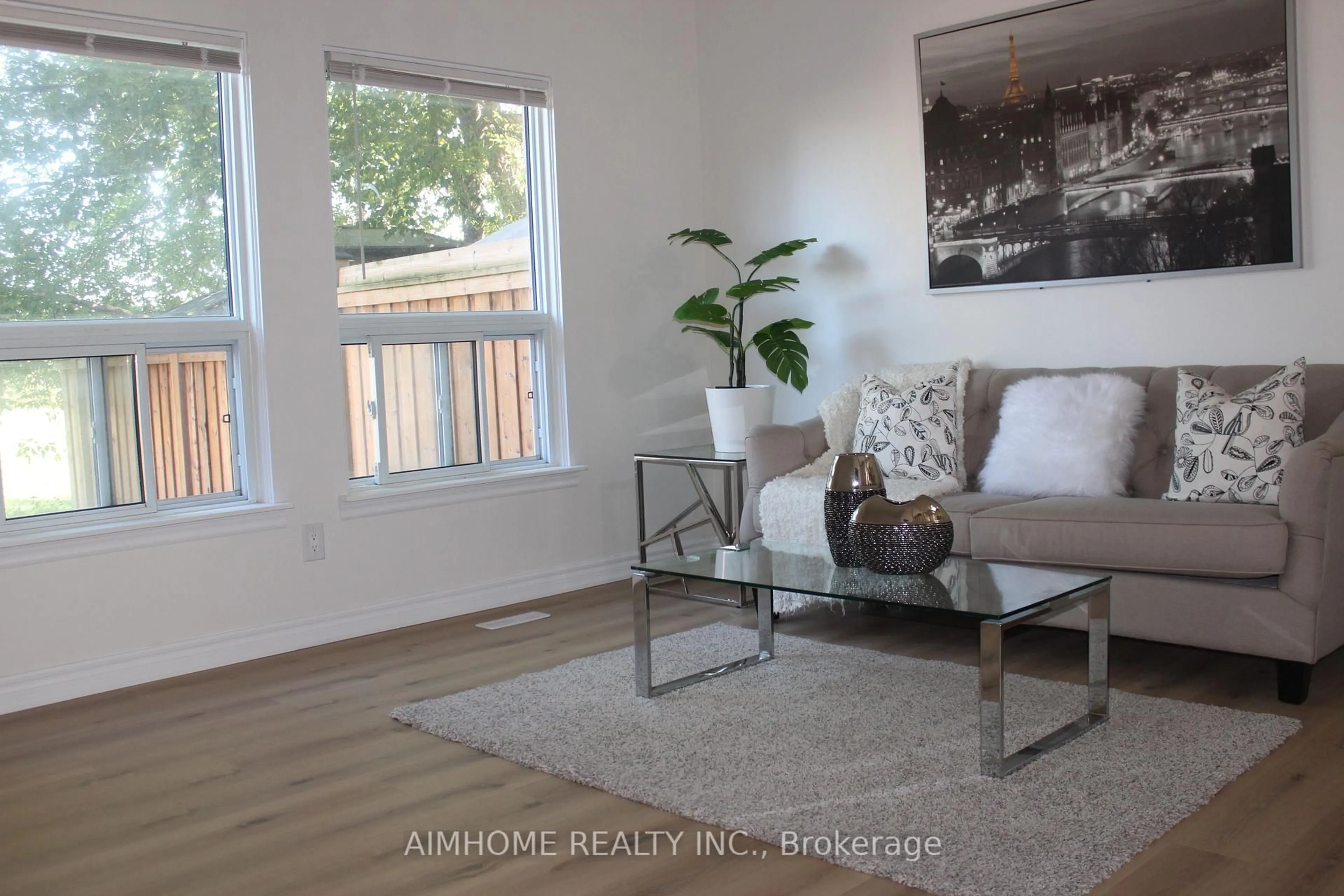 Living room with furniture, wood/laminate floor for 2311 Bridletowne Circ, Toronto Ontario M1W 2L3
