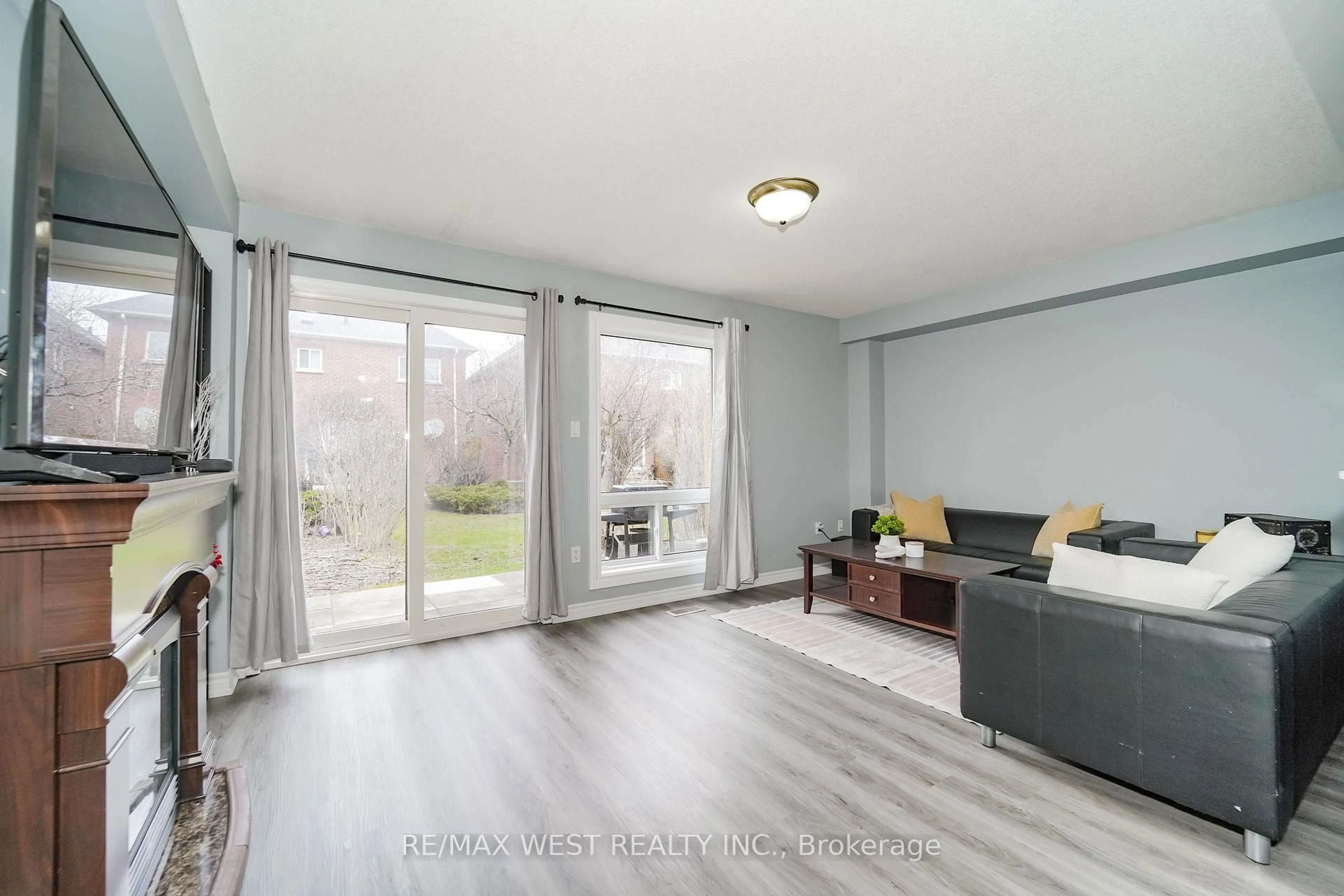Living room with furniture, wood/laminate floor for 52 Torr Lane, Ajax Ontario L1S 7M9