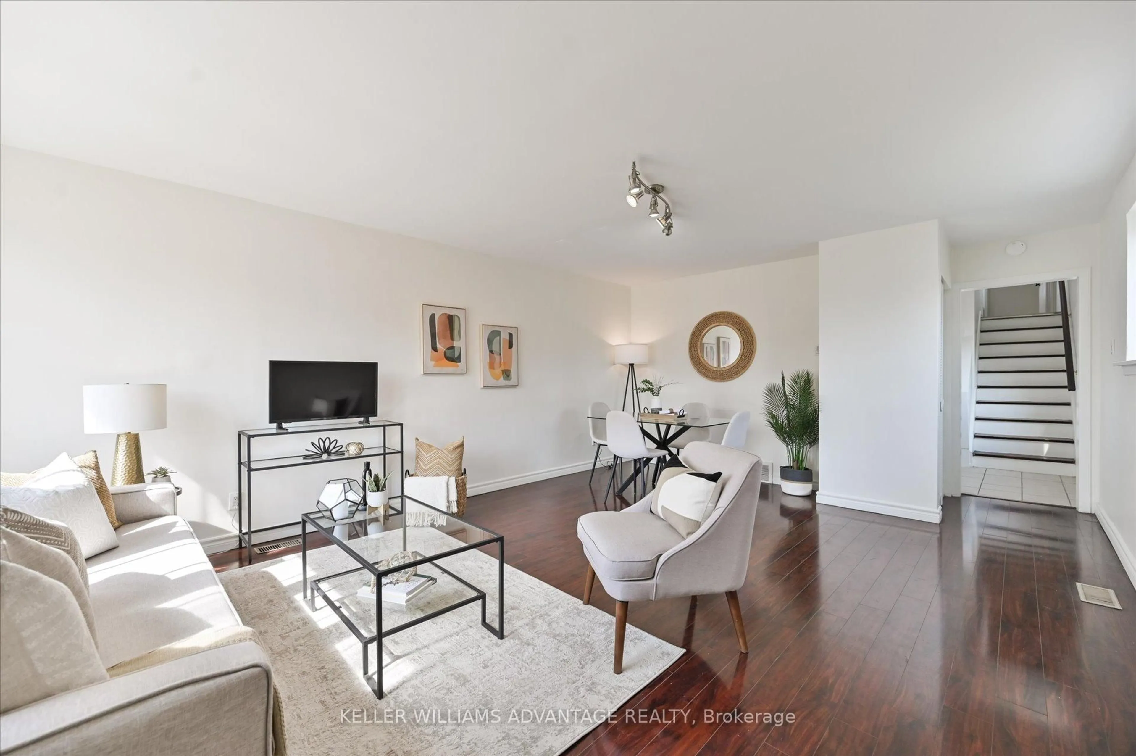 Living room with furniture, wood/laminate floor for 201 Linden Ave, Toronto Ontario M1K 3J1