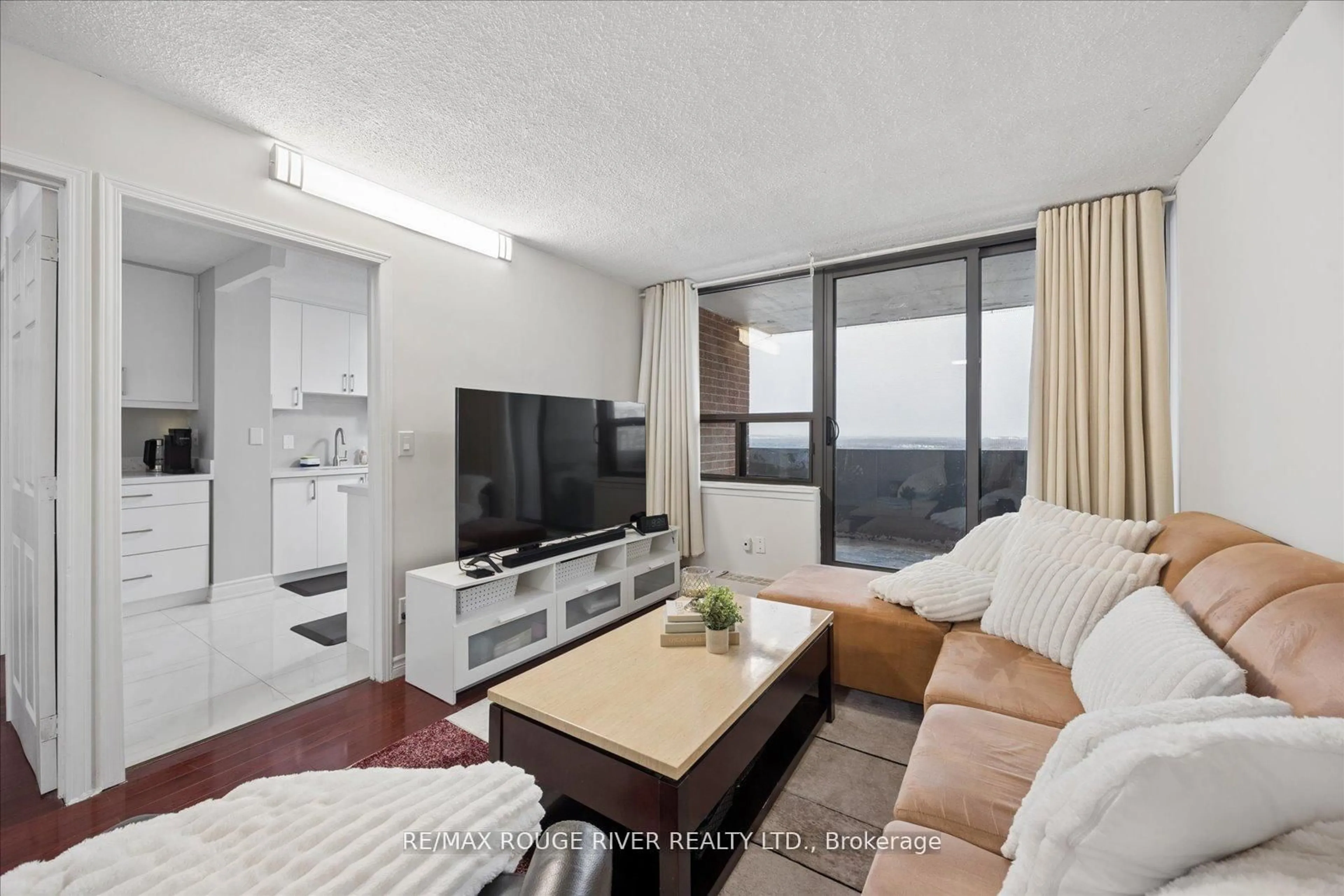 Living room with furniture, wood/laminate floor for 100 Wingarden Crt #1504, Toronto Ontario M1B 2P4