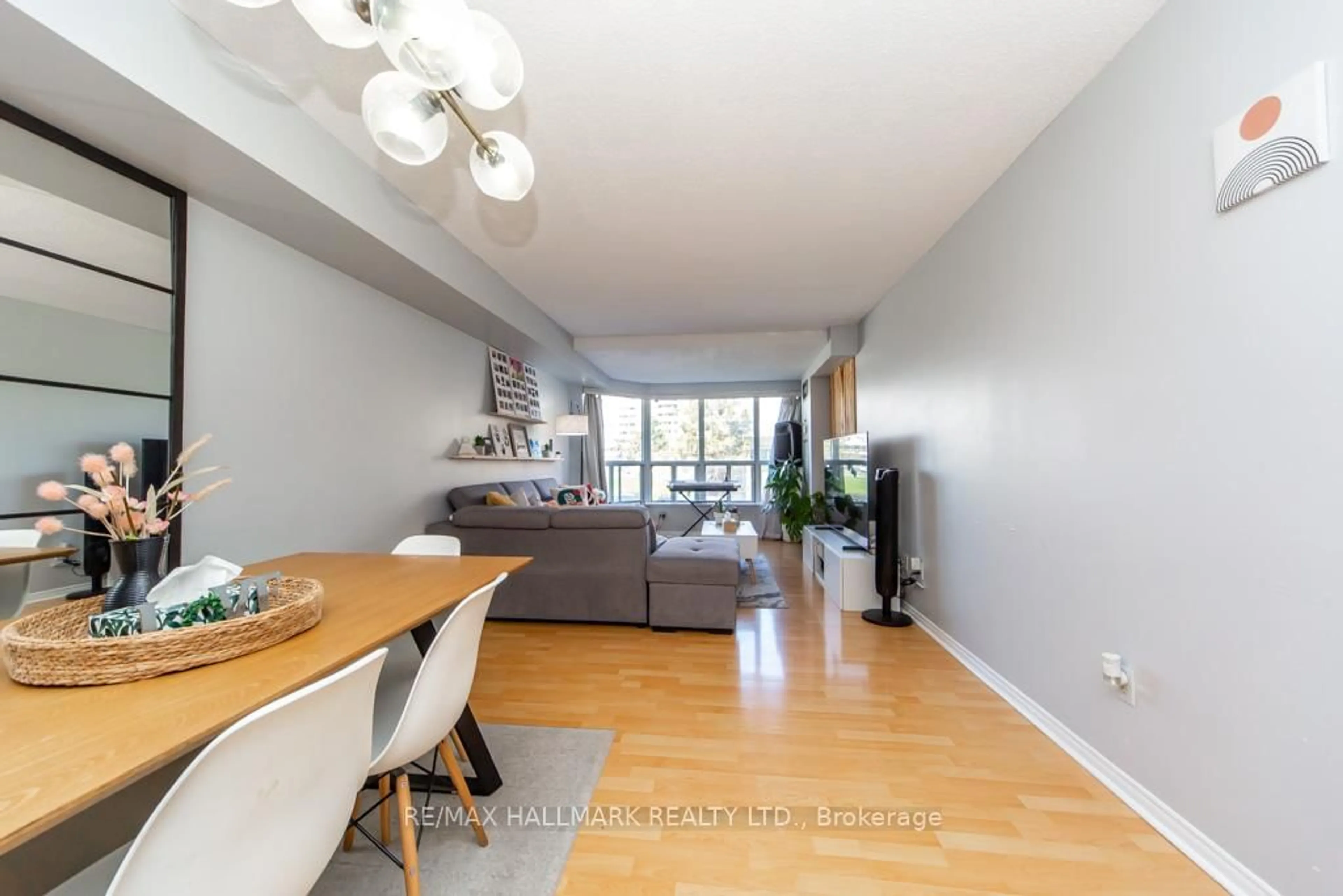 Living room with furniture, wood/laminate floor for 410 McLevin Ave #207, Toronto Ontario M1B 5J5