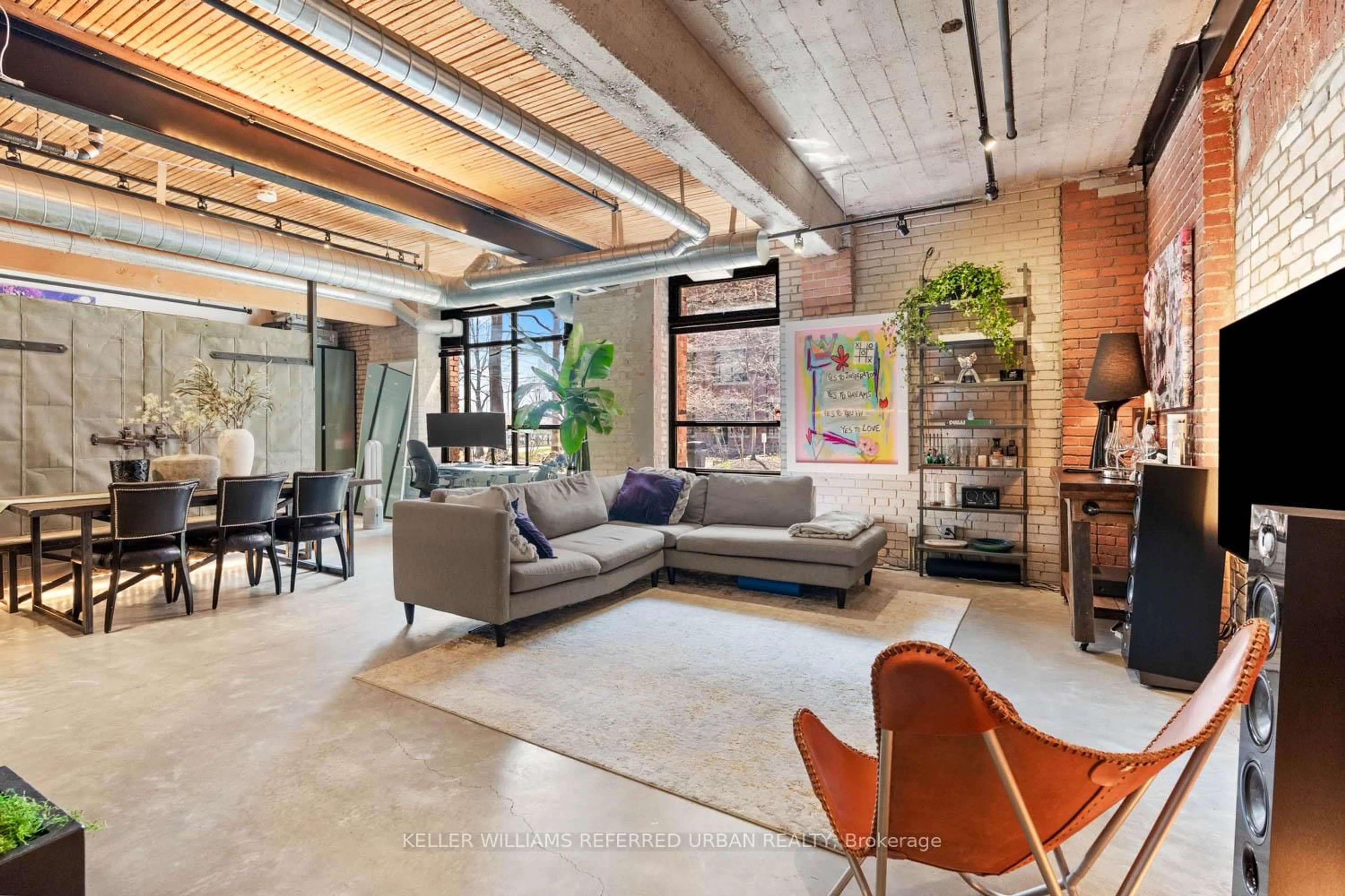 Living room with furniture, cement floor for 68 Broadview Ave #121, Toronto Ontario M4M 2E6