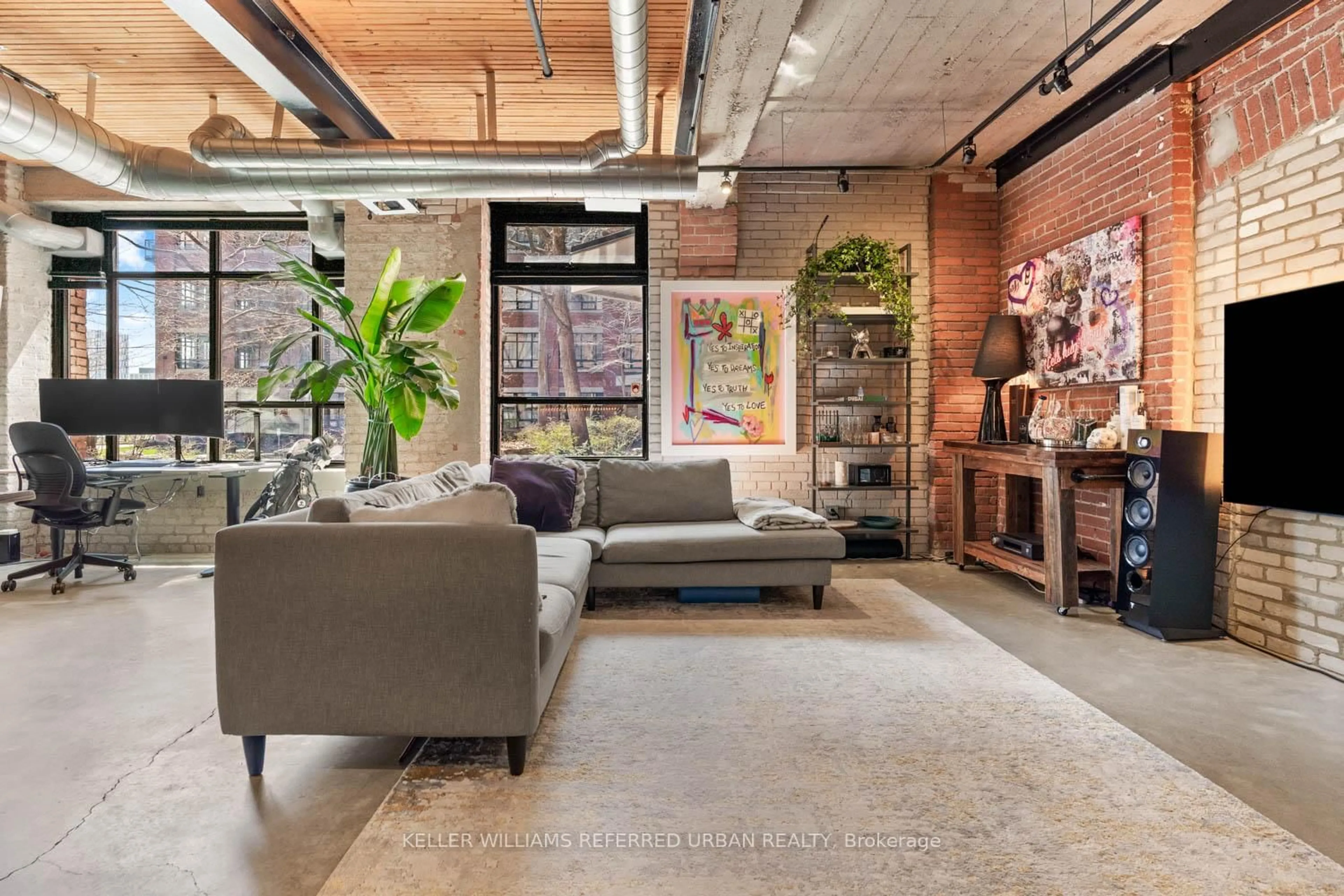 Living room with furniture, cement floor for 68 Broadview Ave #121, Toronto Ontario M4M 2E6