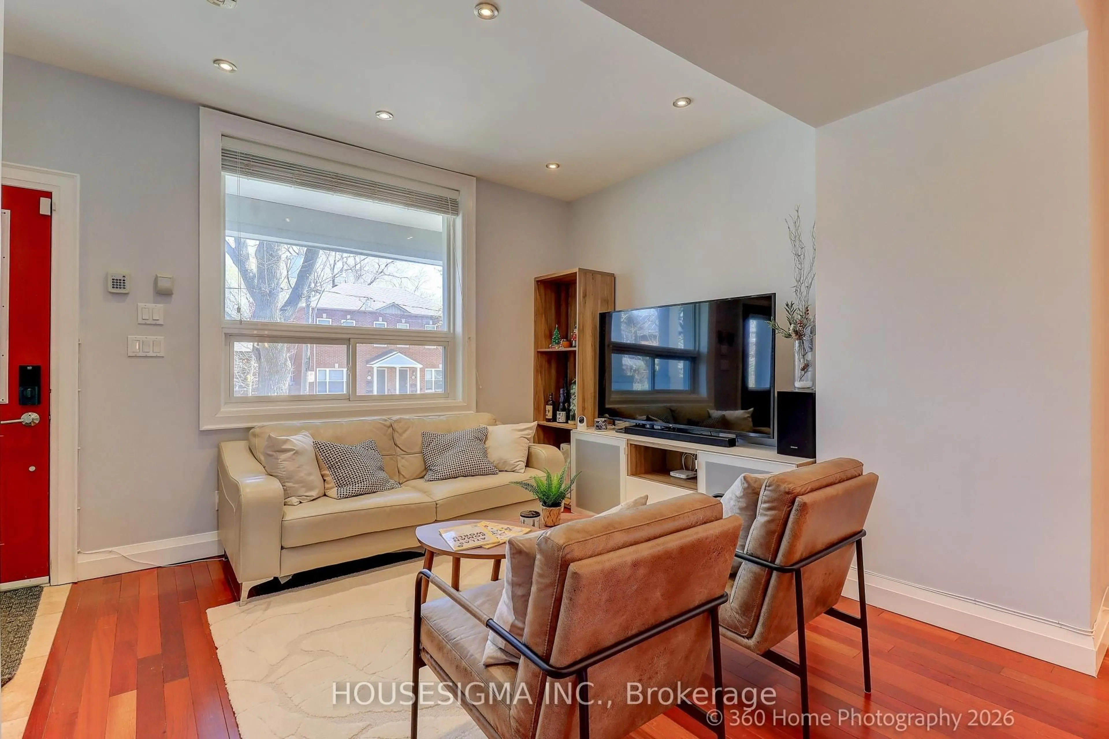 Living room with furniture, wood/laminate floor for 82 Redwood Ave, Toronto Ontario M4L 2S6