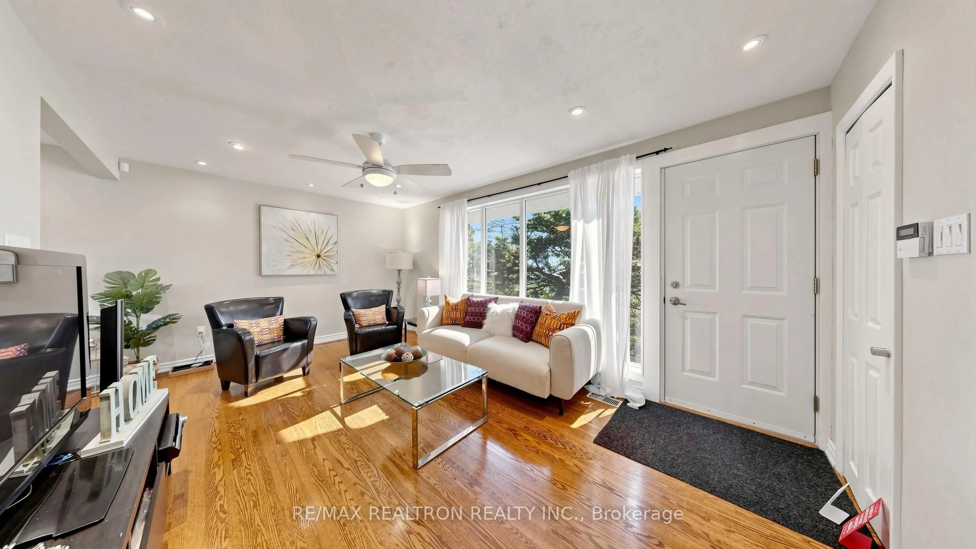 Living room with furniture, wood/laminate floor for 57 Copping Rd, Toronto Ontario M1G 3J9