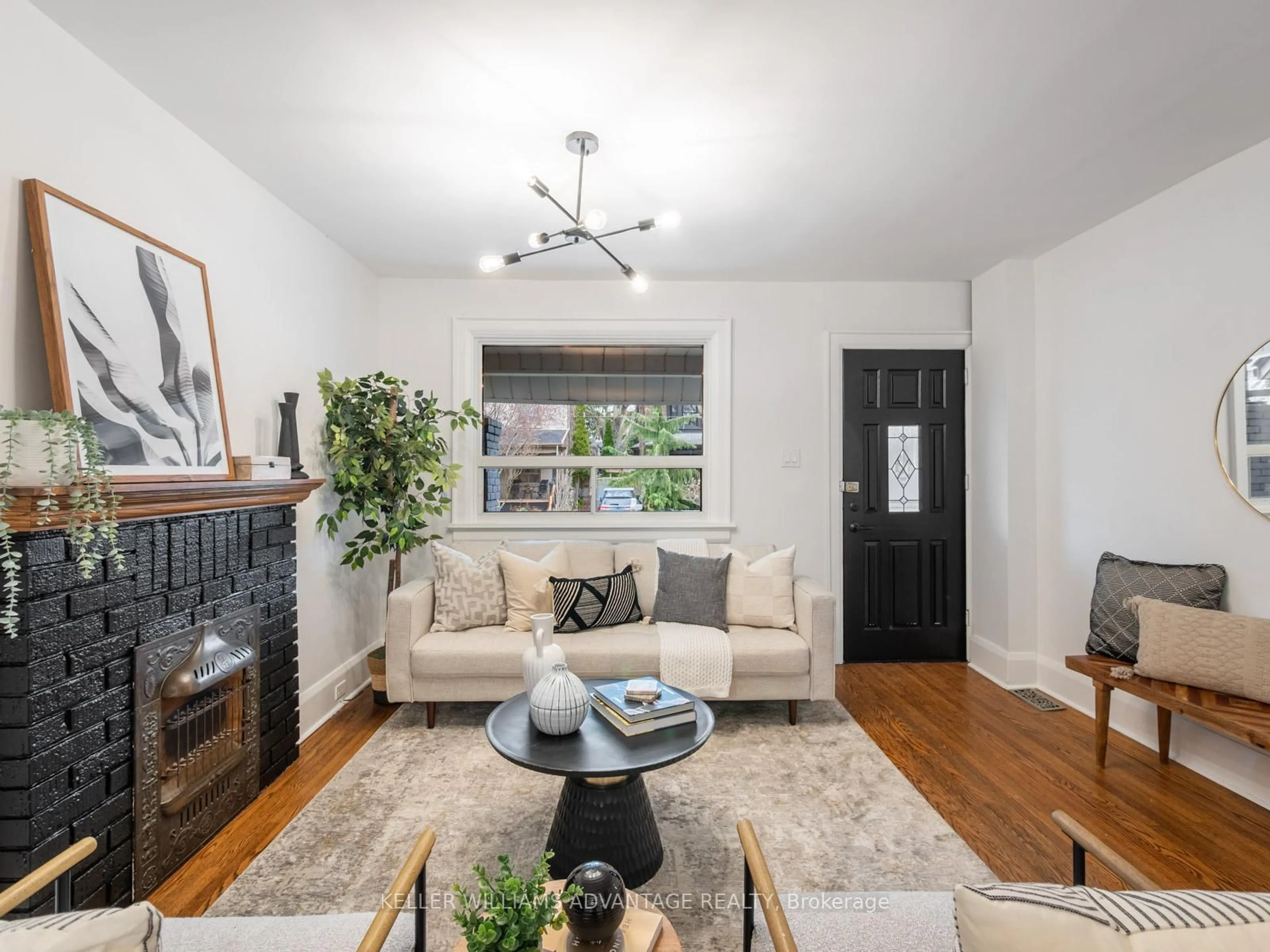 Living room with furniture, wood/laminate floor for 122 Woodfield Rd, Toronto Ontario M4L 2W6