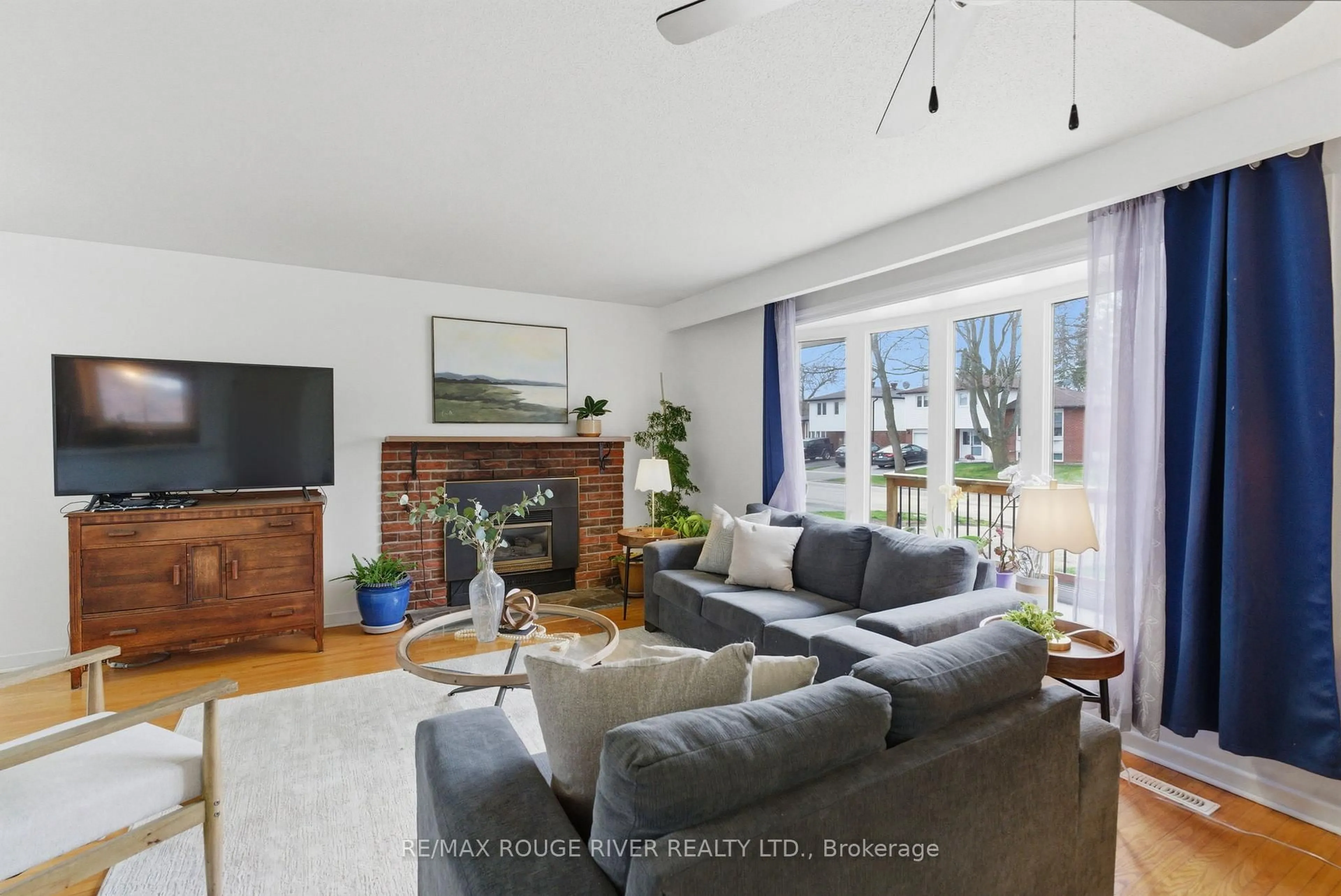 Living room with furniture, wood/laminate floor for 102 Bryant Rd, Ajax Ontario L1S 2Y8