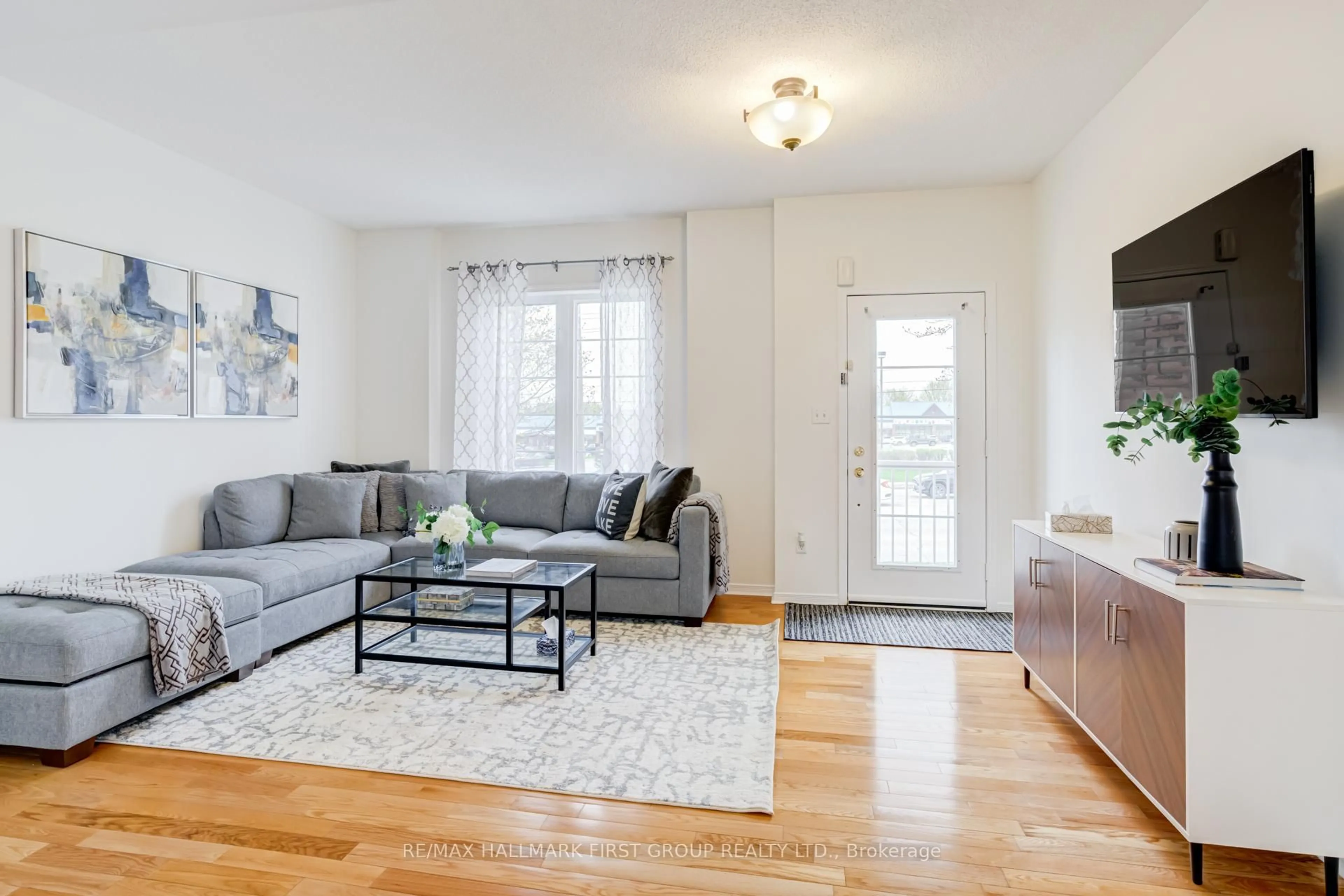Living room with furniture, wood/laminate floor for 144 Bayly St, Ajax Ontario L1S 0C3