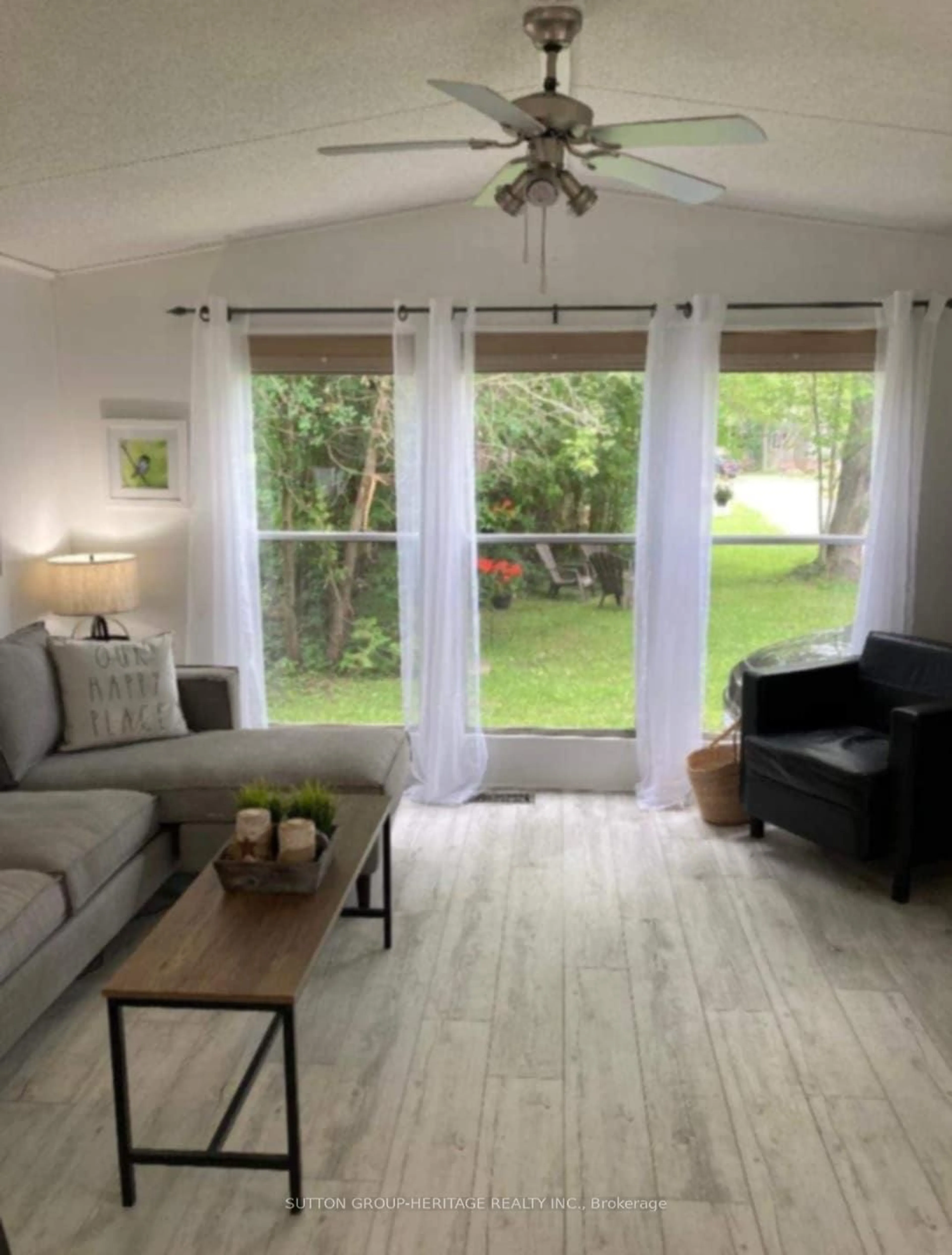 Living room with furniture, wood/laminate floor for 225 Platten Blvd #636, Scugog Ontario L9L 1B4