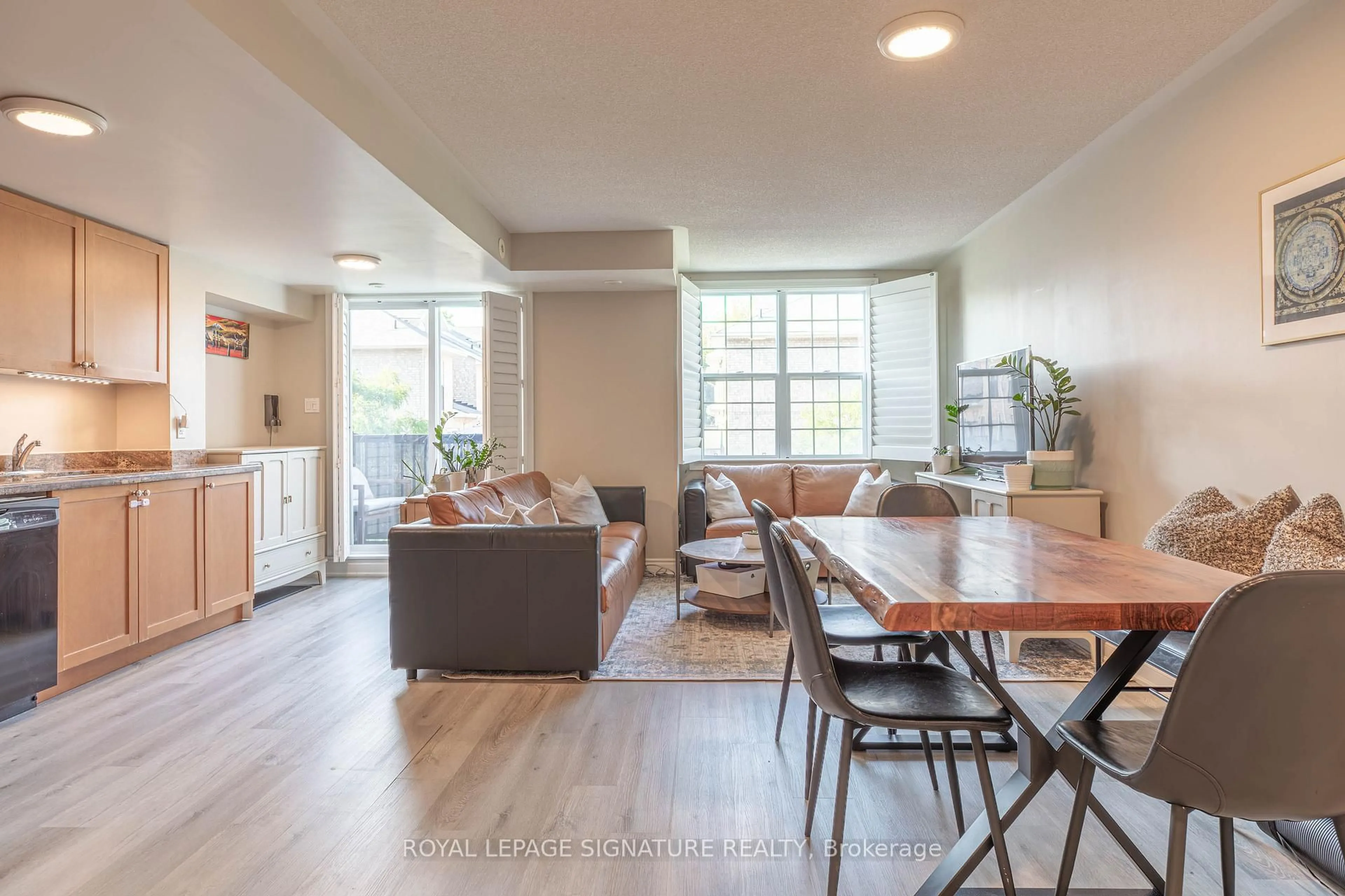 Living room with furniture, wood/laminate floor for 45 Strangford Lane #309, Toronto Ontario M1L 0E5