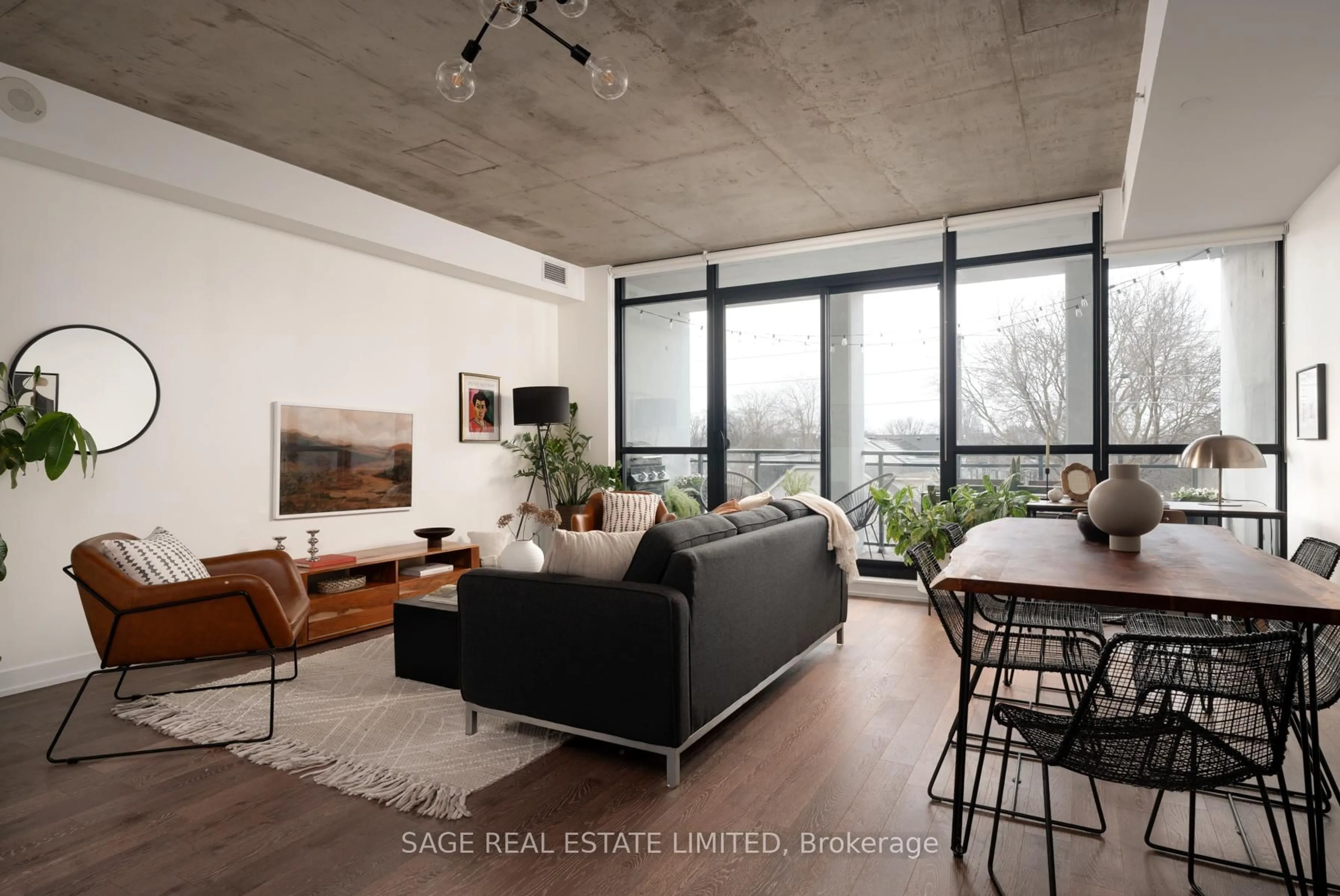 Living room with furniture, cement floor for 1238 Dundas St #403, Toronto Ontario M4M 1S3