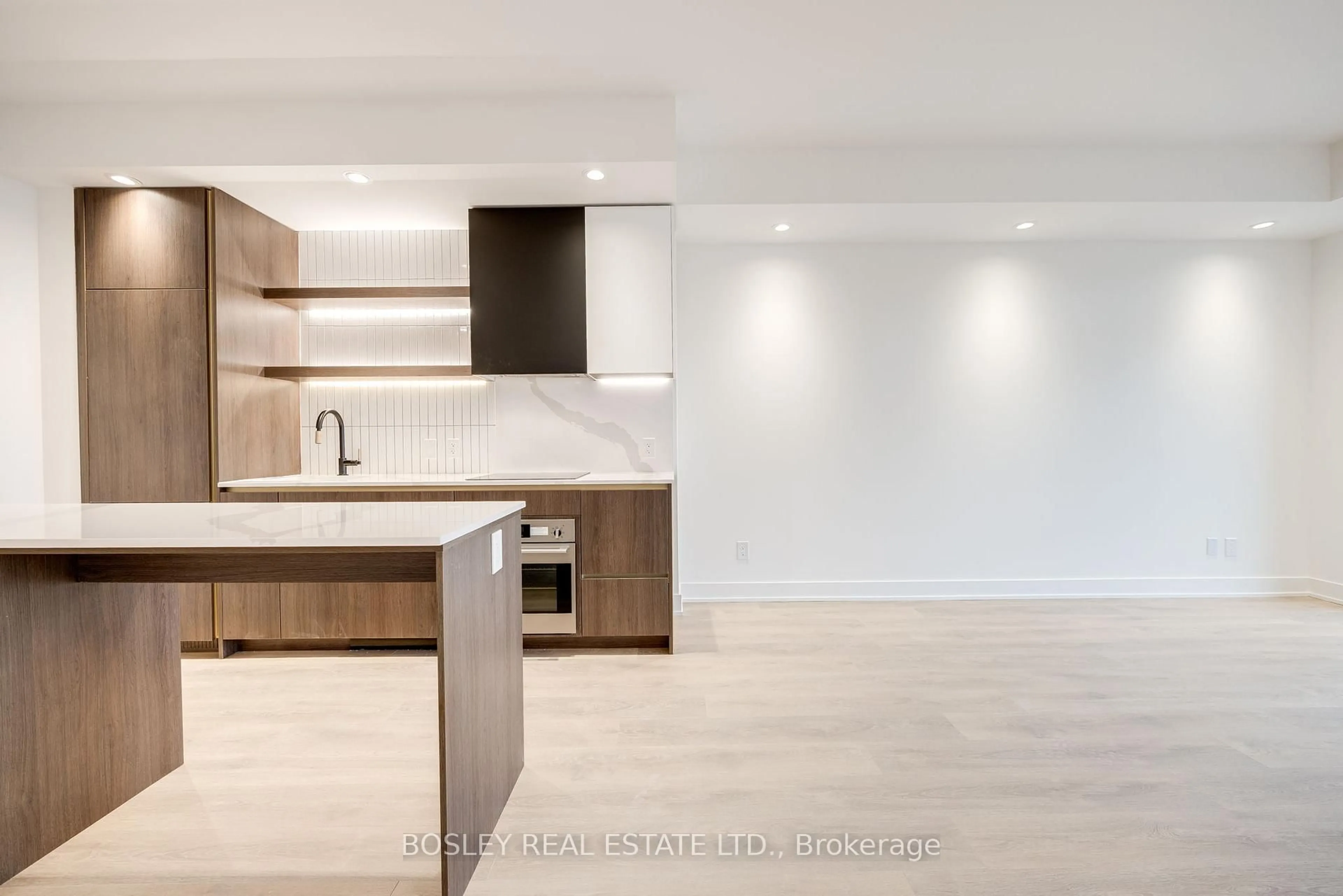 Open concept kitchen, wood/laminate floor for 1285 Queen St #204, Toronto Ontario M4L 1C2