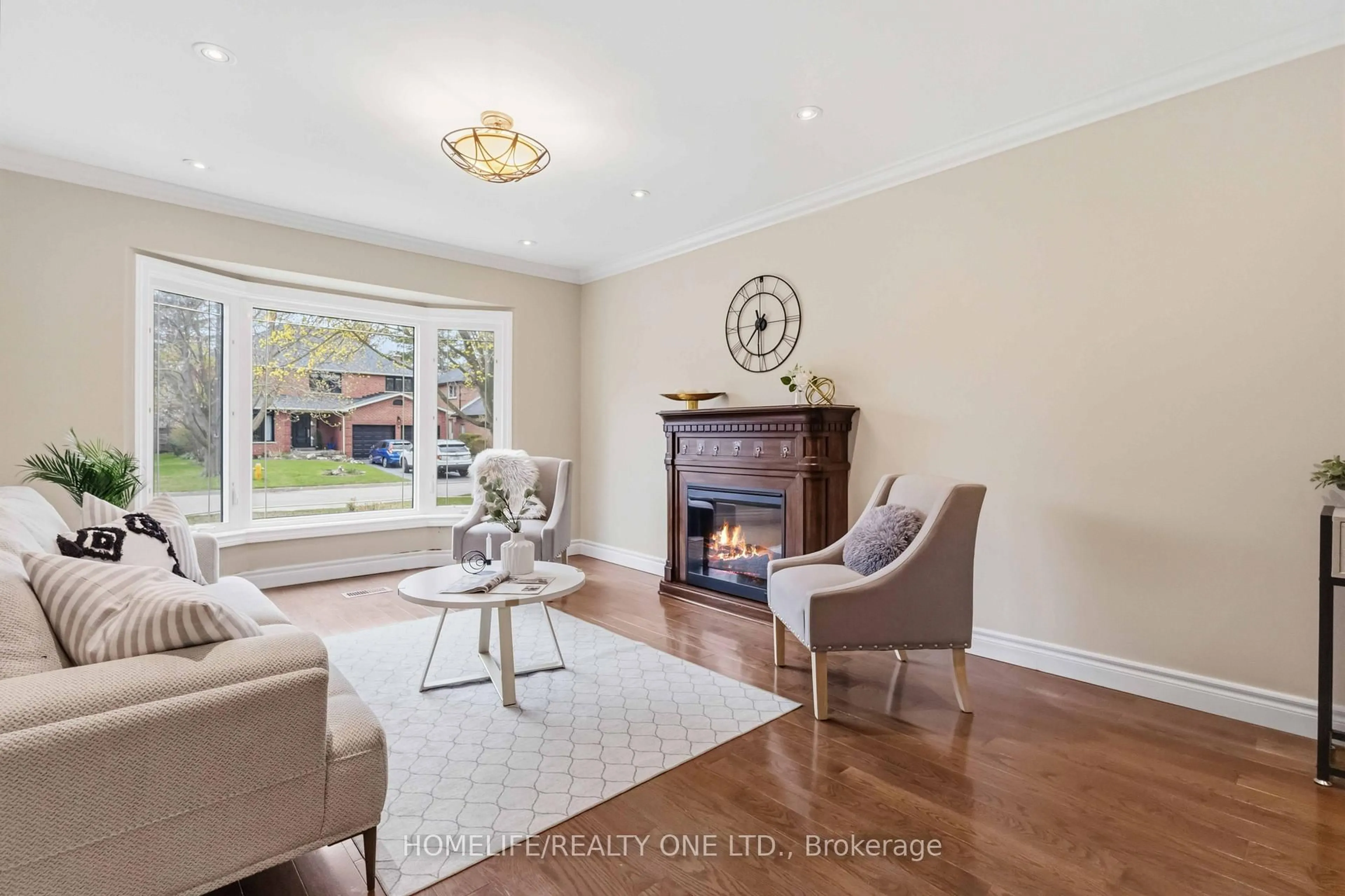 Living room with furniture, wood/laminate floor for 75 Windrush Tr, Toronto Ontario M1C 3Z9