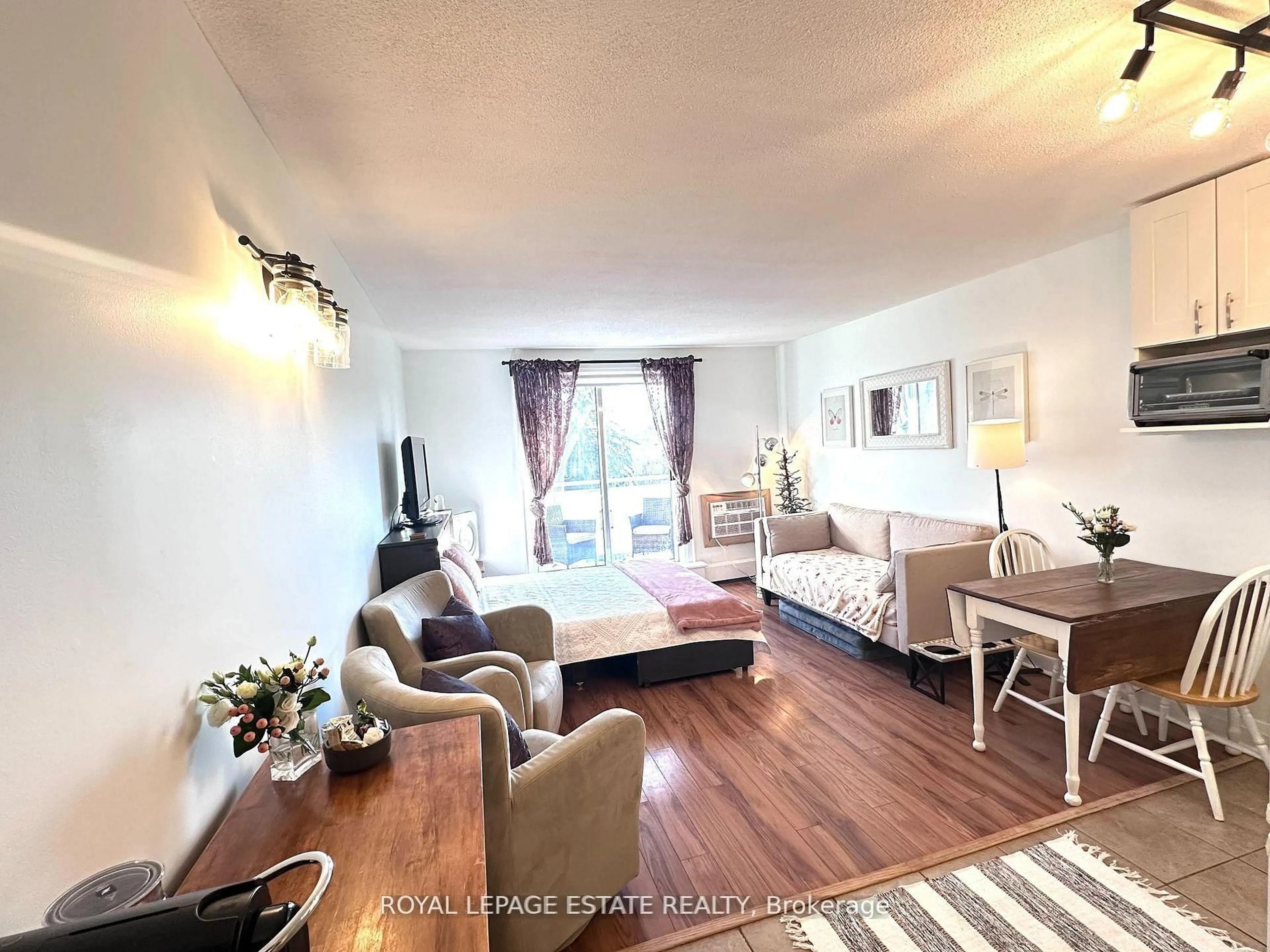 Living room with furniture, wood/laminate floor for 123 Woodbine Ave #309, Toronto Ontario M4L 3V8