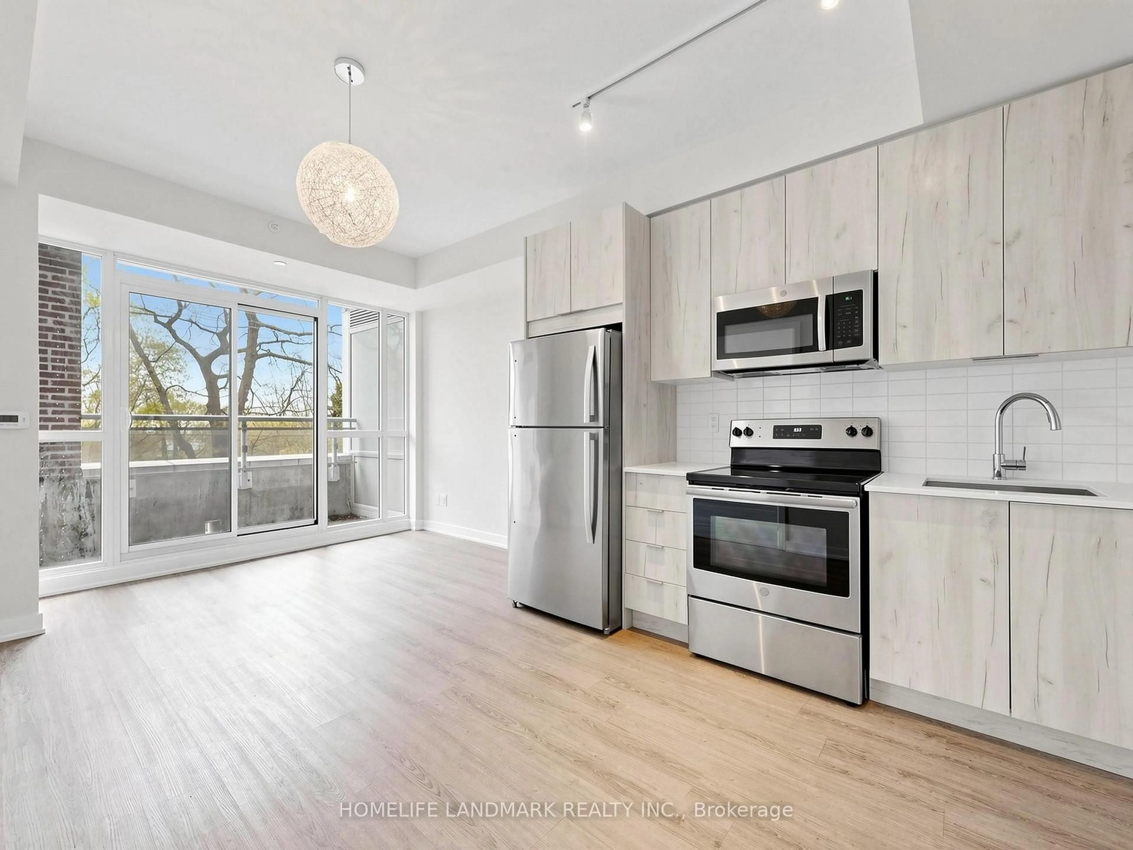 Open concept kitchen, wood/laminate floor for 1350 Kingston Rd #209, Toronto Ontario M1N 0B7
