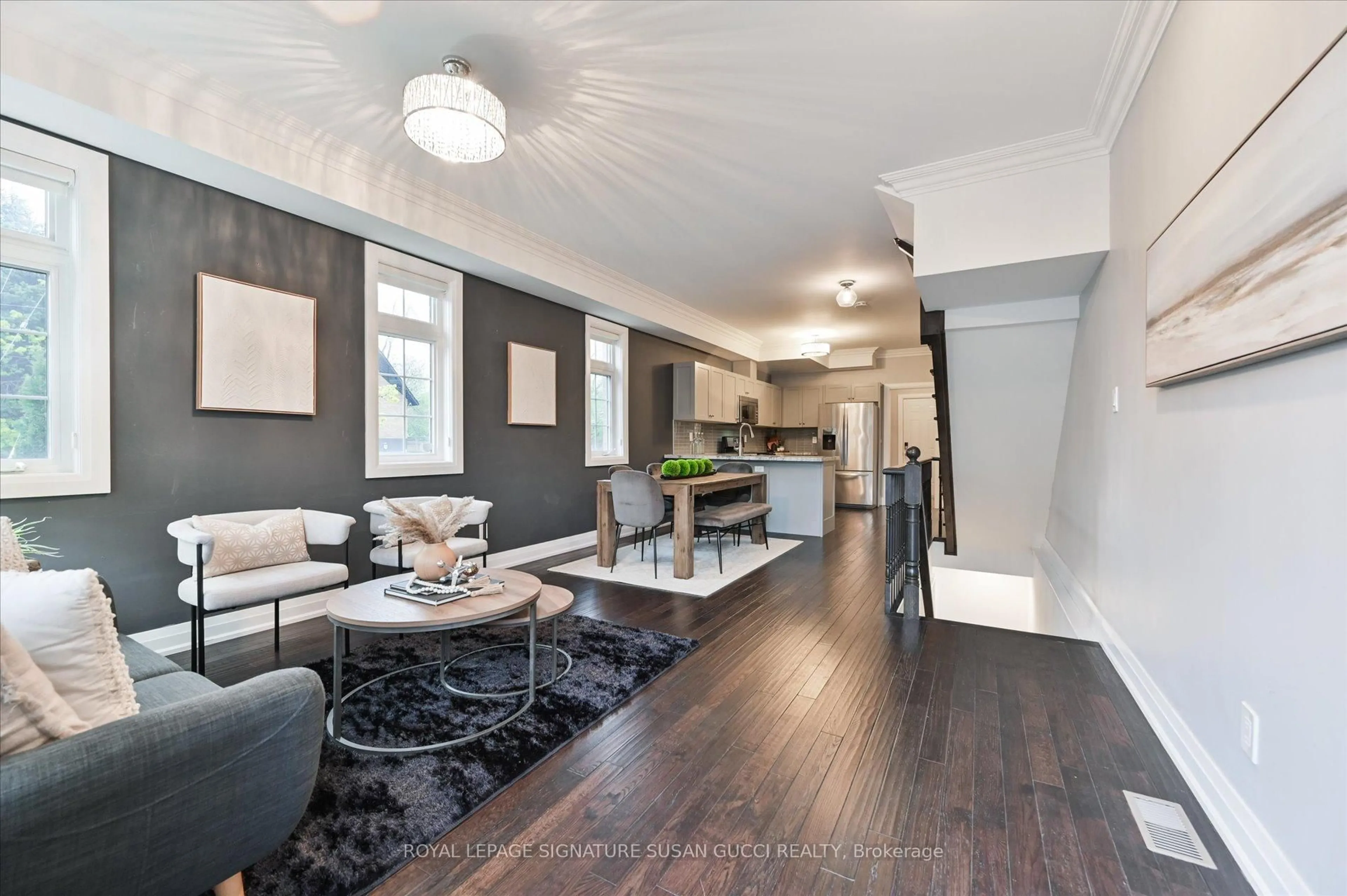Living room with furniture, wood/laminate floor for 2833 St. Clair Ave, Toronto Ontario M4B 1N3