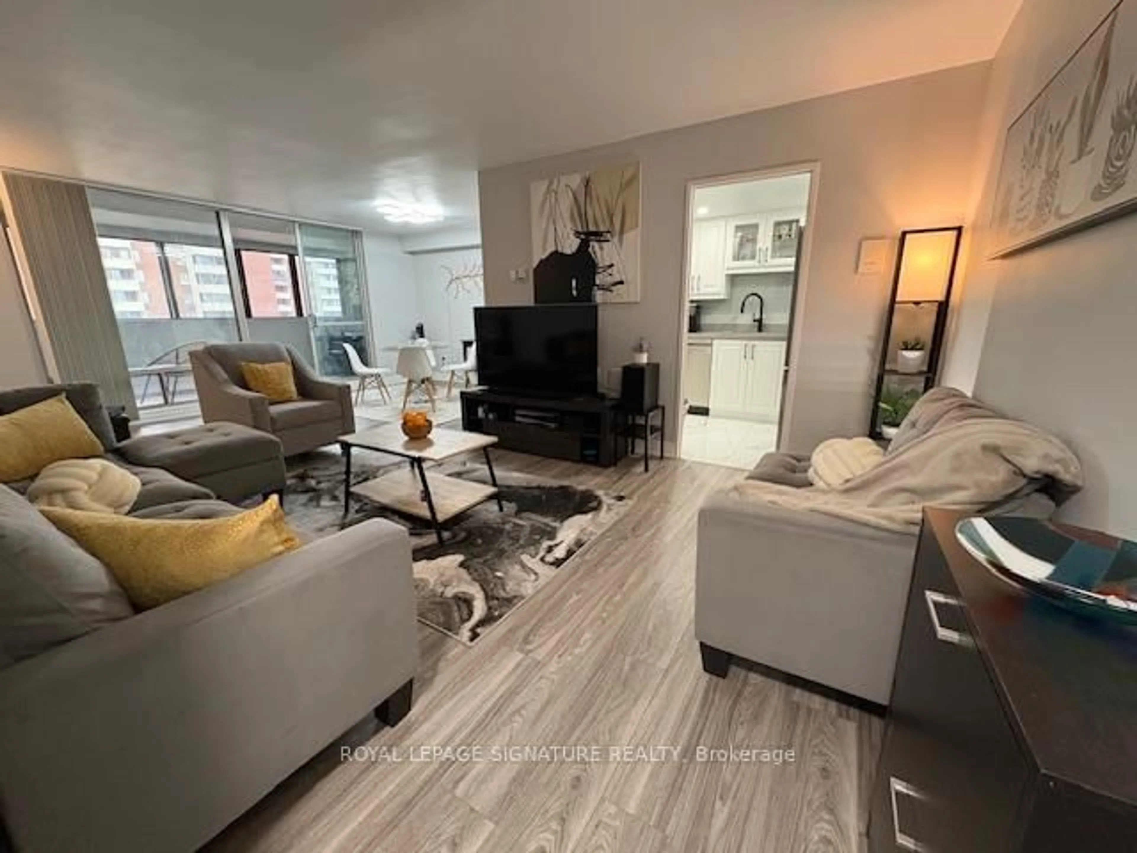 Living room with furniture, wood/laminate floor for 5 Massey Sq #1701, Toronto Ontario M4C 5L6