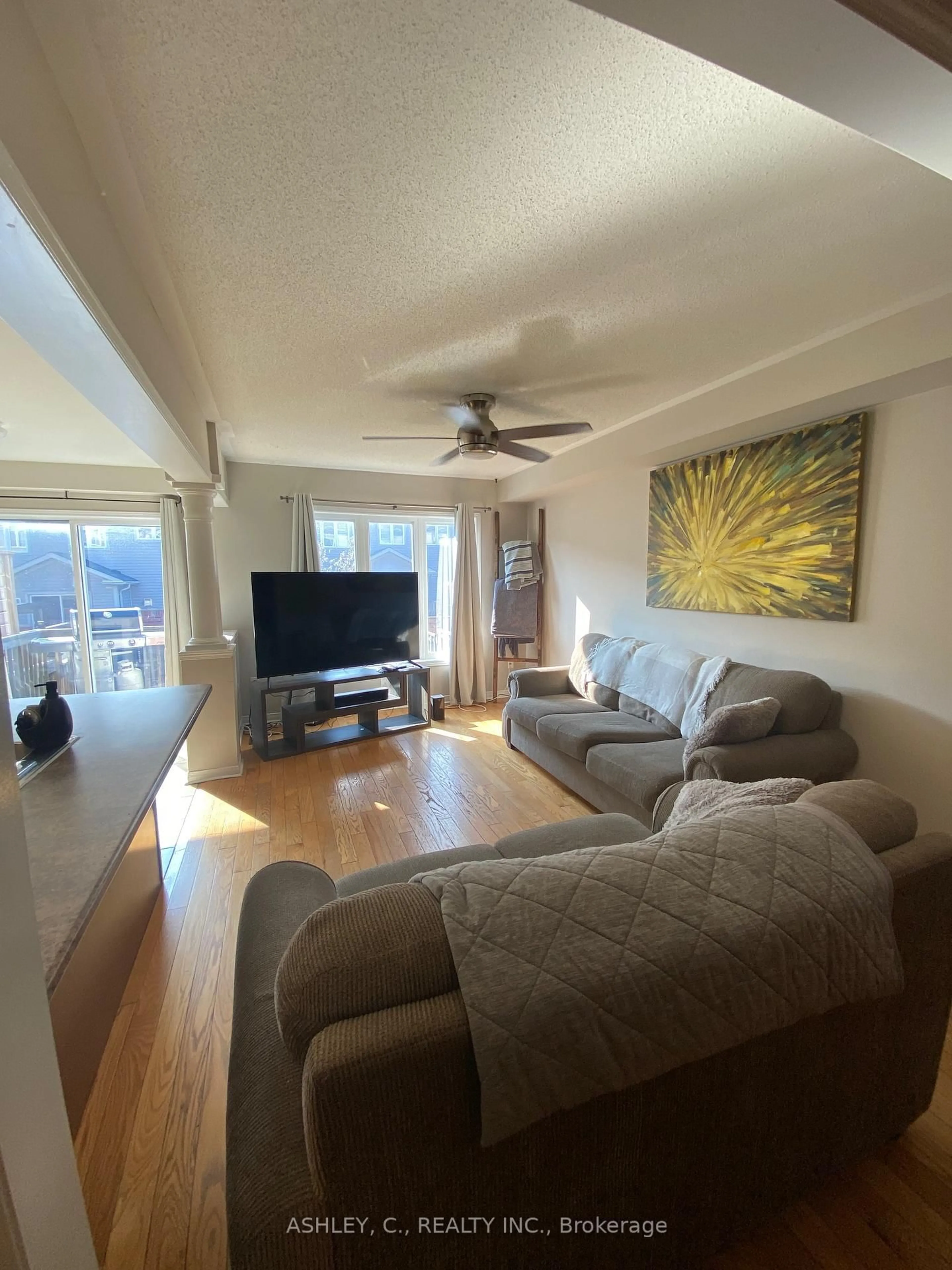 Living room with furniture, wood/laminate floor for 104 James Govan Dr, Whitby Ontario L1N 0J7