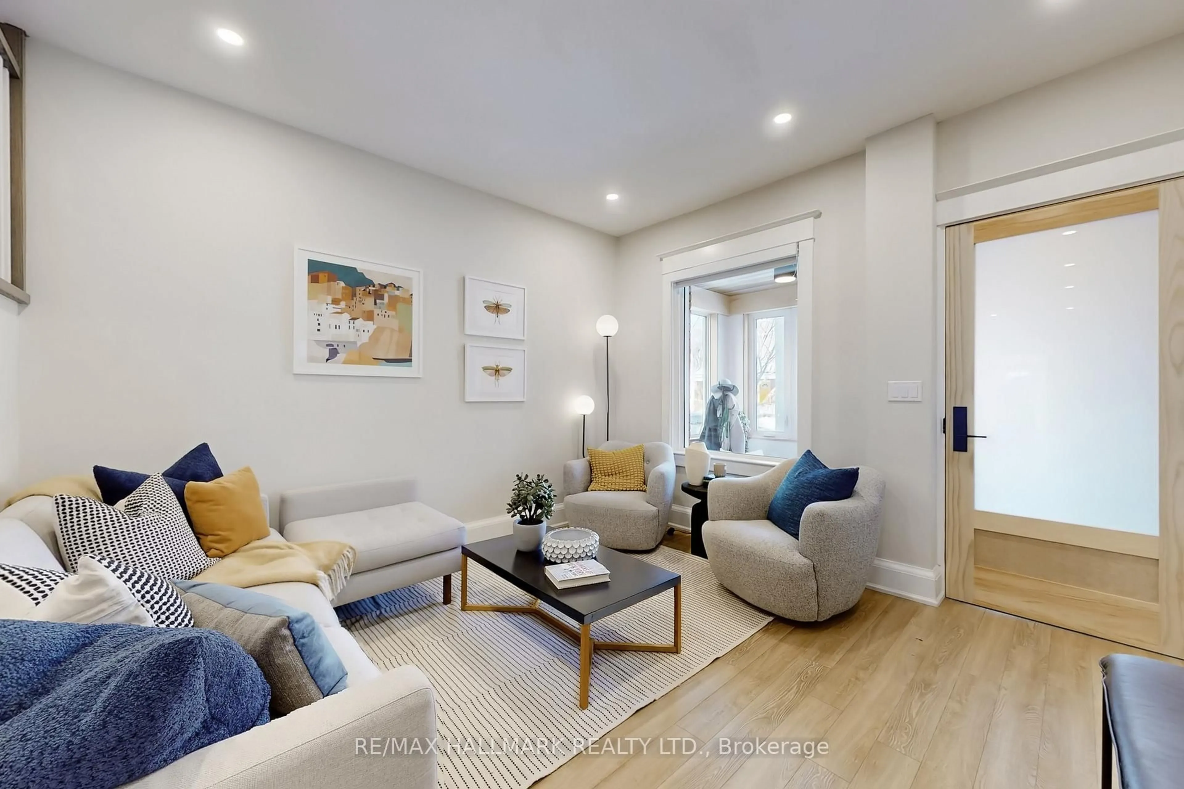 Living room with furniture, wood/laminate floor for 72 Hastings Ave, Toronto Ontario M4L 2L2