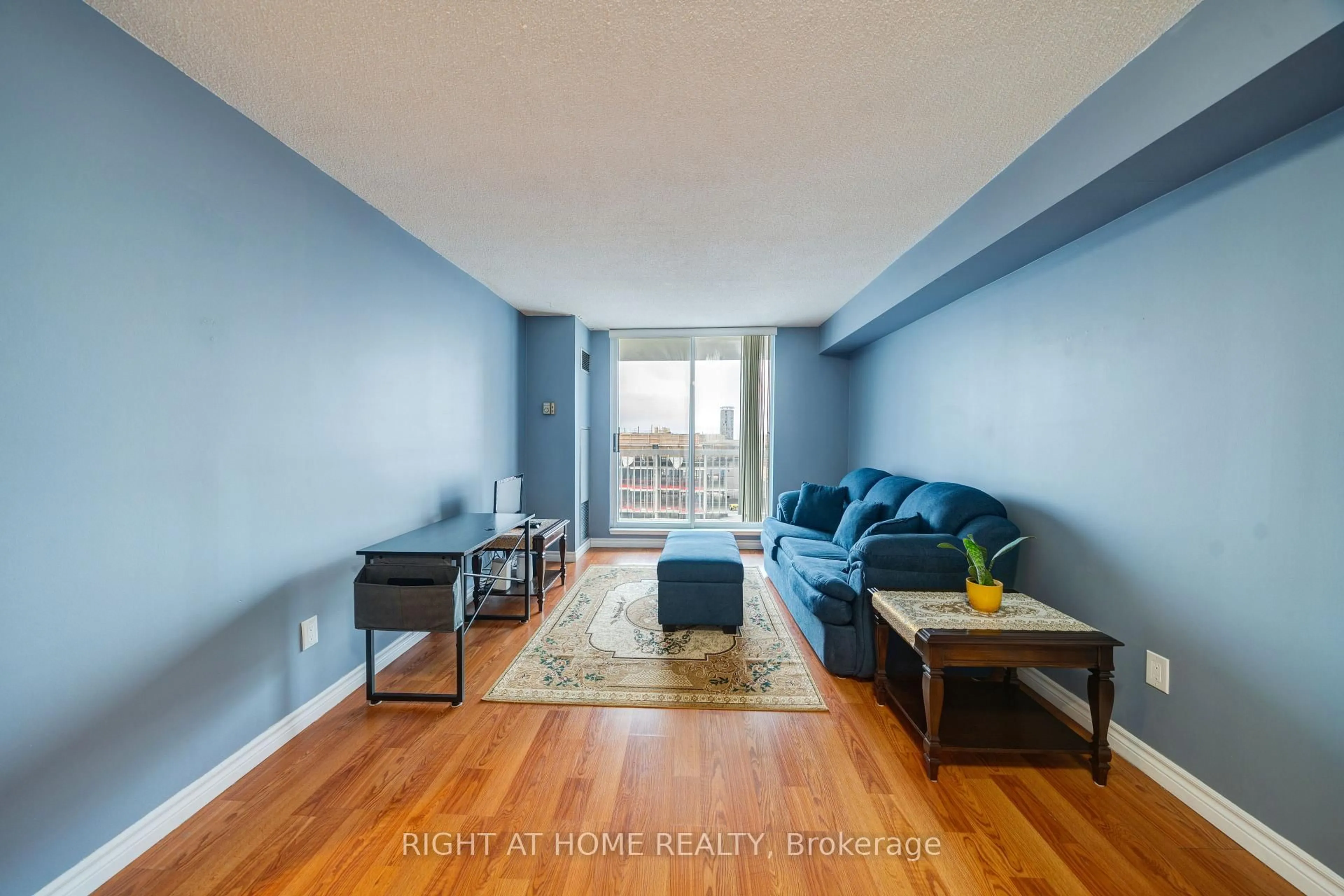 Living room with furniture, wood/laminate floor for 15 Sewells Rd #1005, Toronto Ontario M1B 3J7