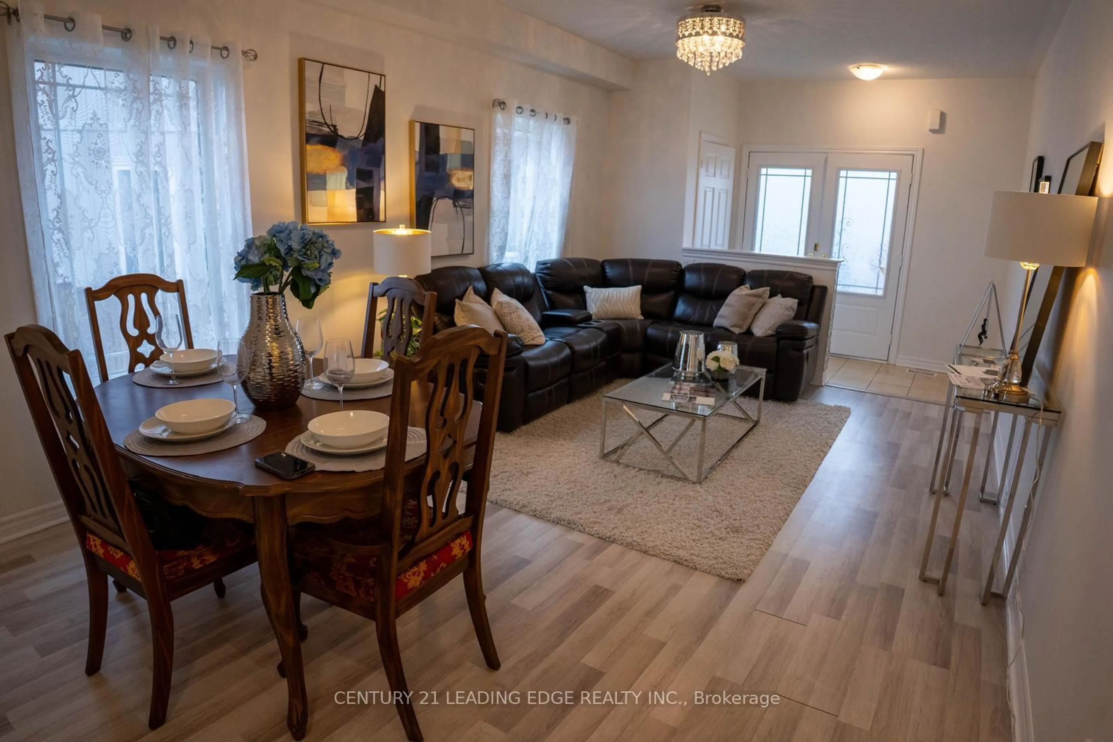 Living room with furniture, wood/laminate floor for 27 Mantz Cres, Whitby Ontario L1R 0L3